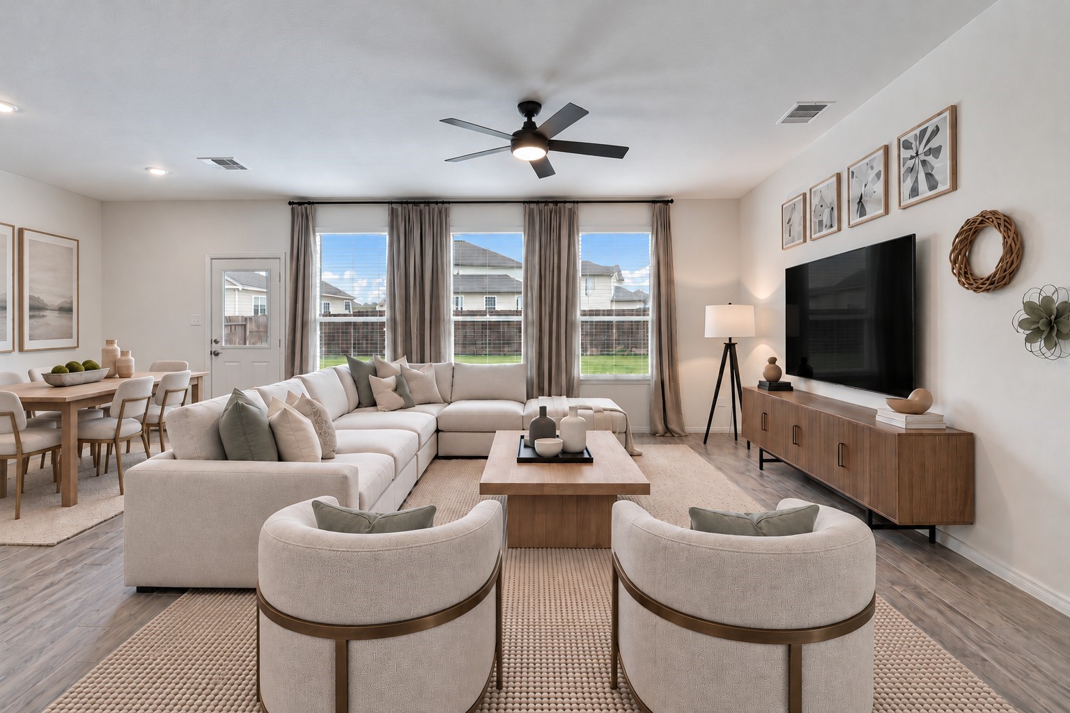 Virtually Staged: A modern ceiling fan with integrated lighting provides added comfort, while the high ceilings contribute to the room's airy, expansive feel.