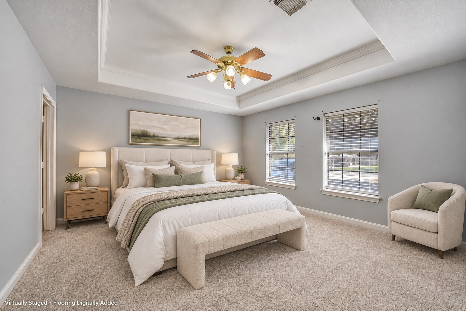 Staged primary bedroom to show how it will look like with carpeting and furniture.
