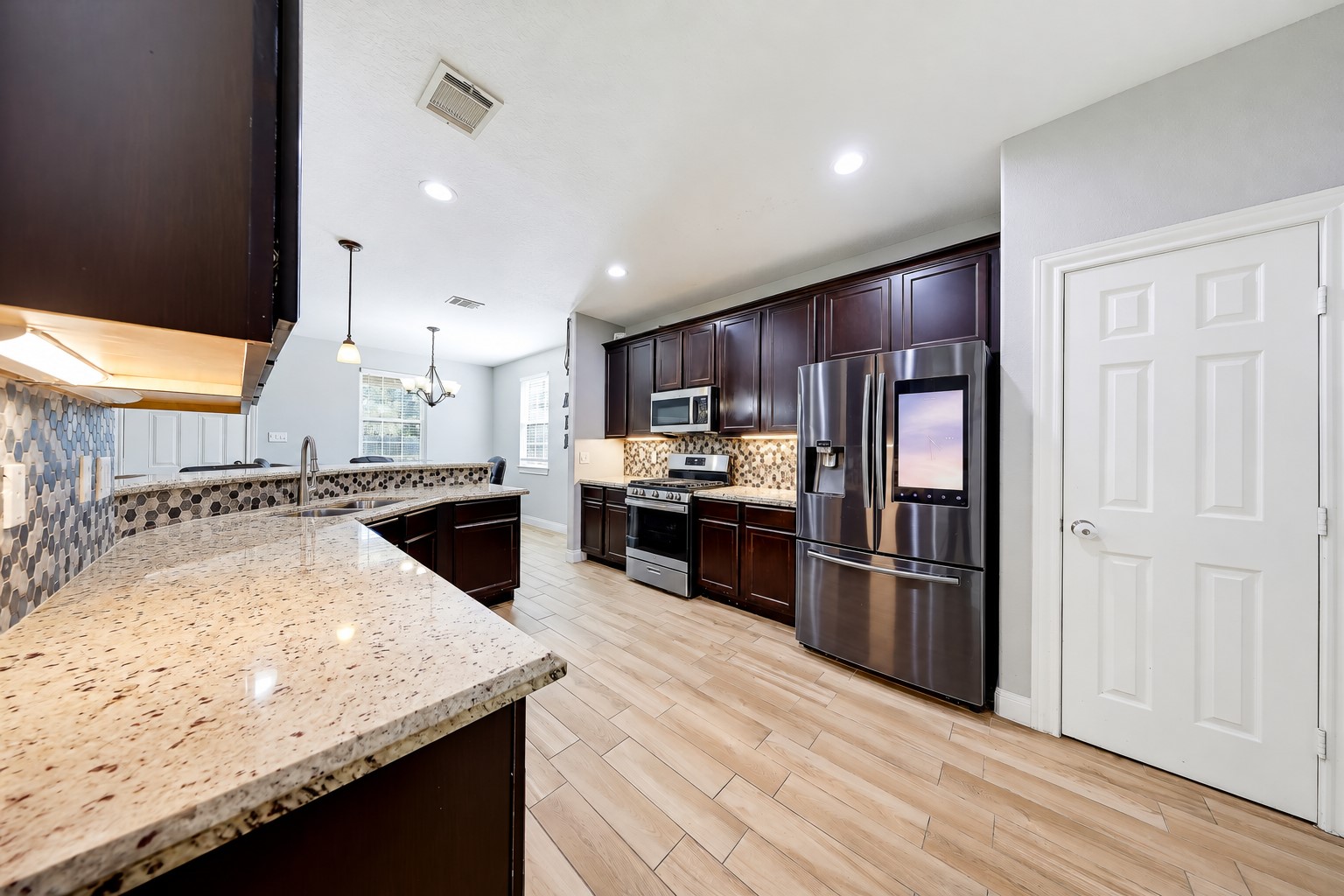 Granite counters and rich wood cabinetry give you a beautiful backdrop for everyday meals.