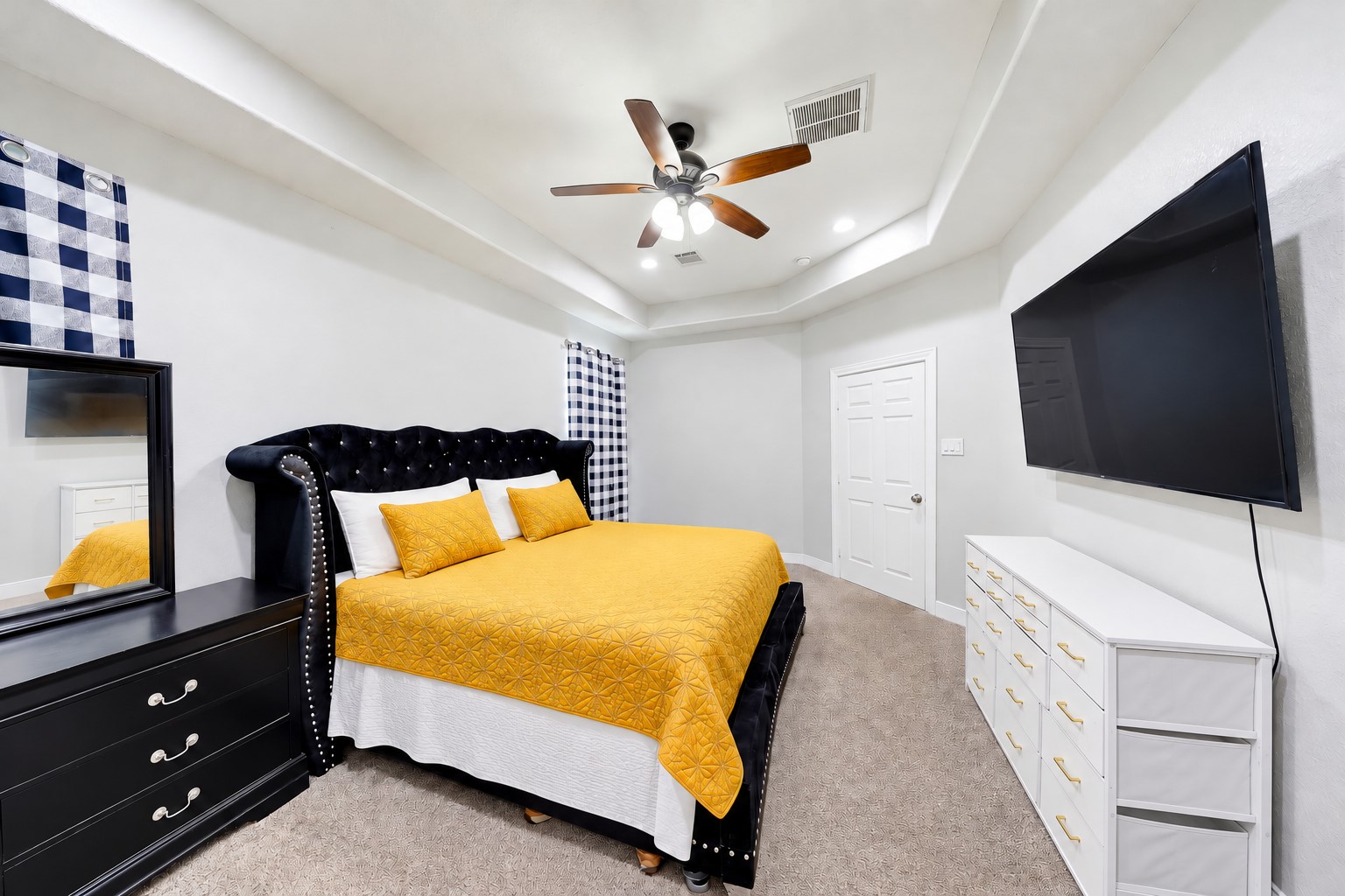 Stretch out and unwind in your spacious primary retreat beneath an elegant tray ceiling.