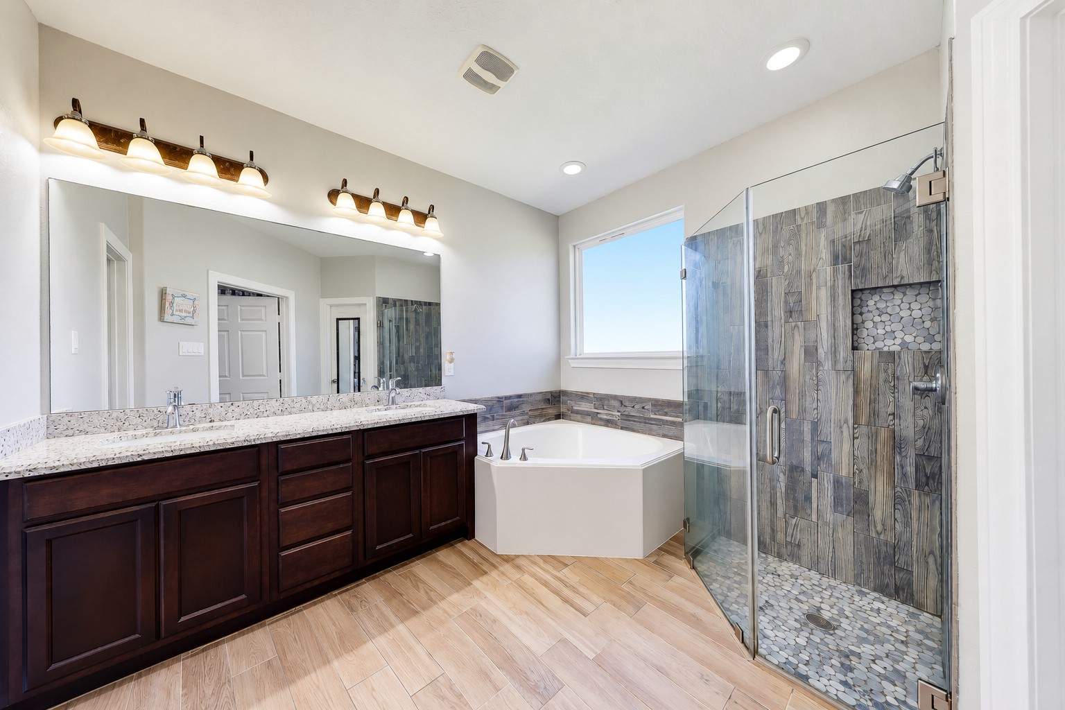 Recharge your way with double sinks, a soaking tub, and a separate glass-enclosed shower.