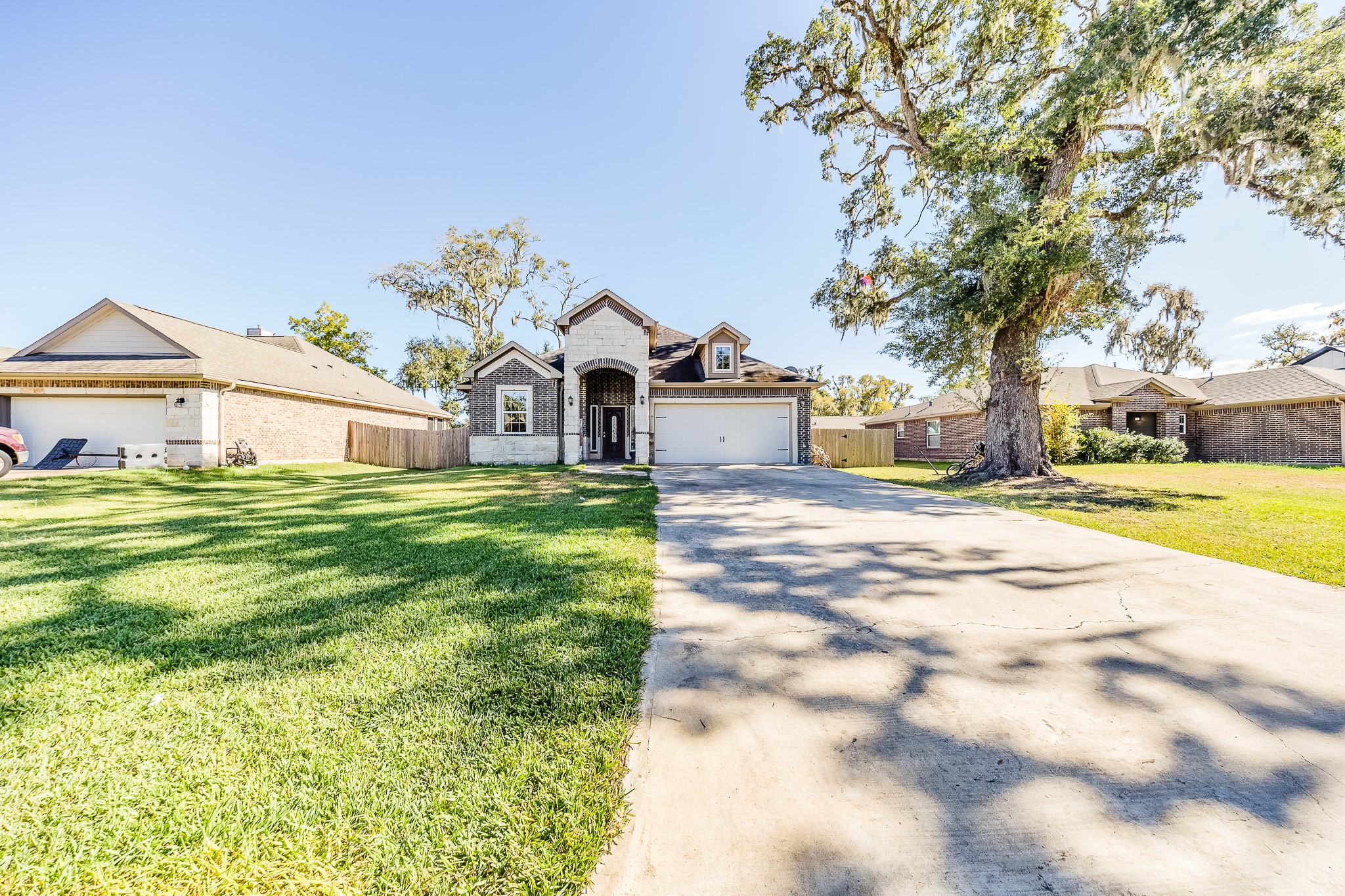Come home to an inviting setting framed by mature trees and an expansive front lawn.