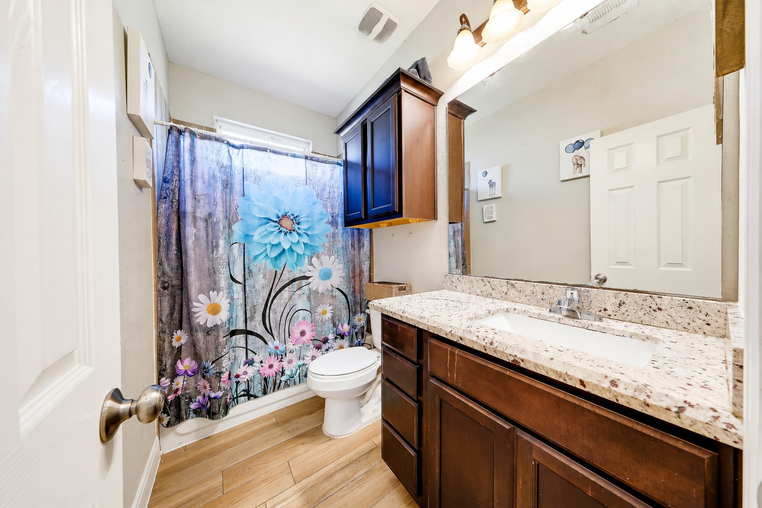 A secondary bathroom with a tub-and-shower combination makes daily routines easy.