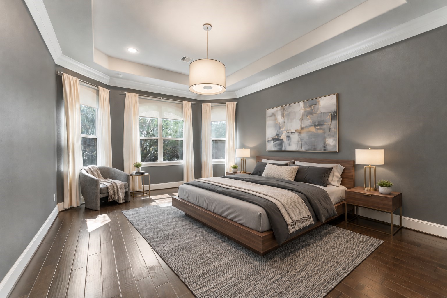 Luxurious primary suite featuring elegant crown molding, tray ceilings, and views of the beautiful backyard. (Virtually staged)