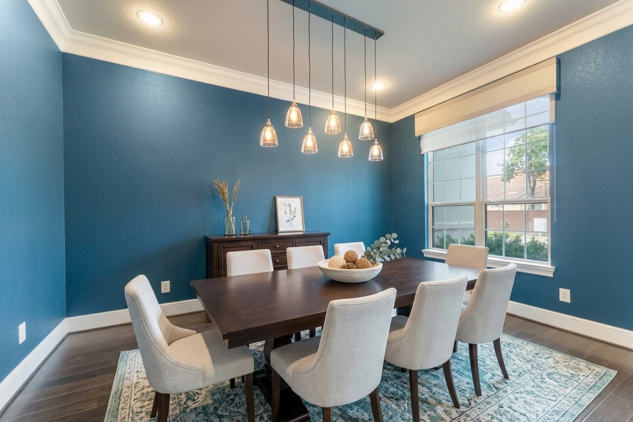 Elegant formal dining room featuring rich flooring and ample space for entertaining. (Virtually staged)