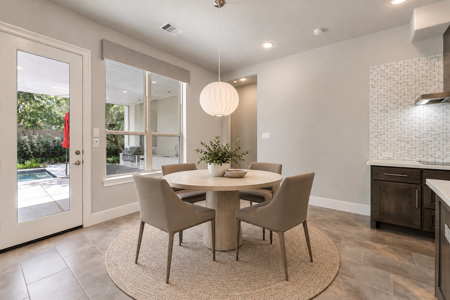 Bright breakfast room overlooking the pool and covered back patio (Virtually staged)