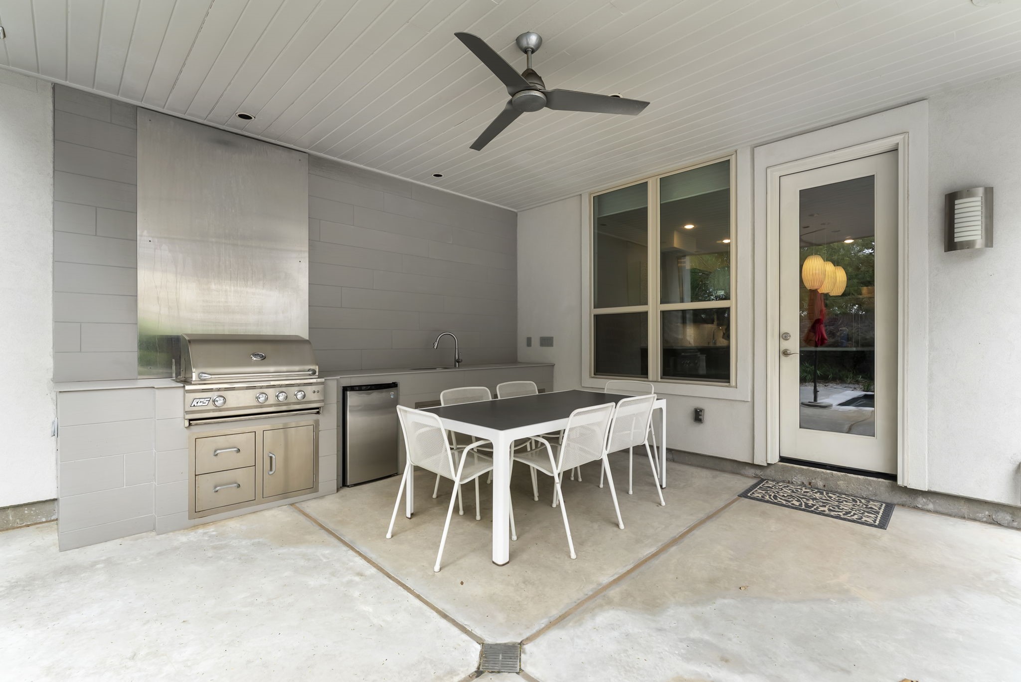 Summer kitchen with built-in grill & pool view for year round enjoyment!
