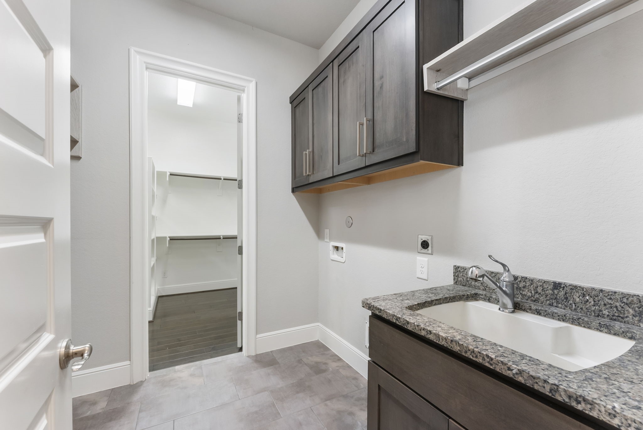 The oversized primary closet directly connects to the utility room.