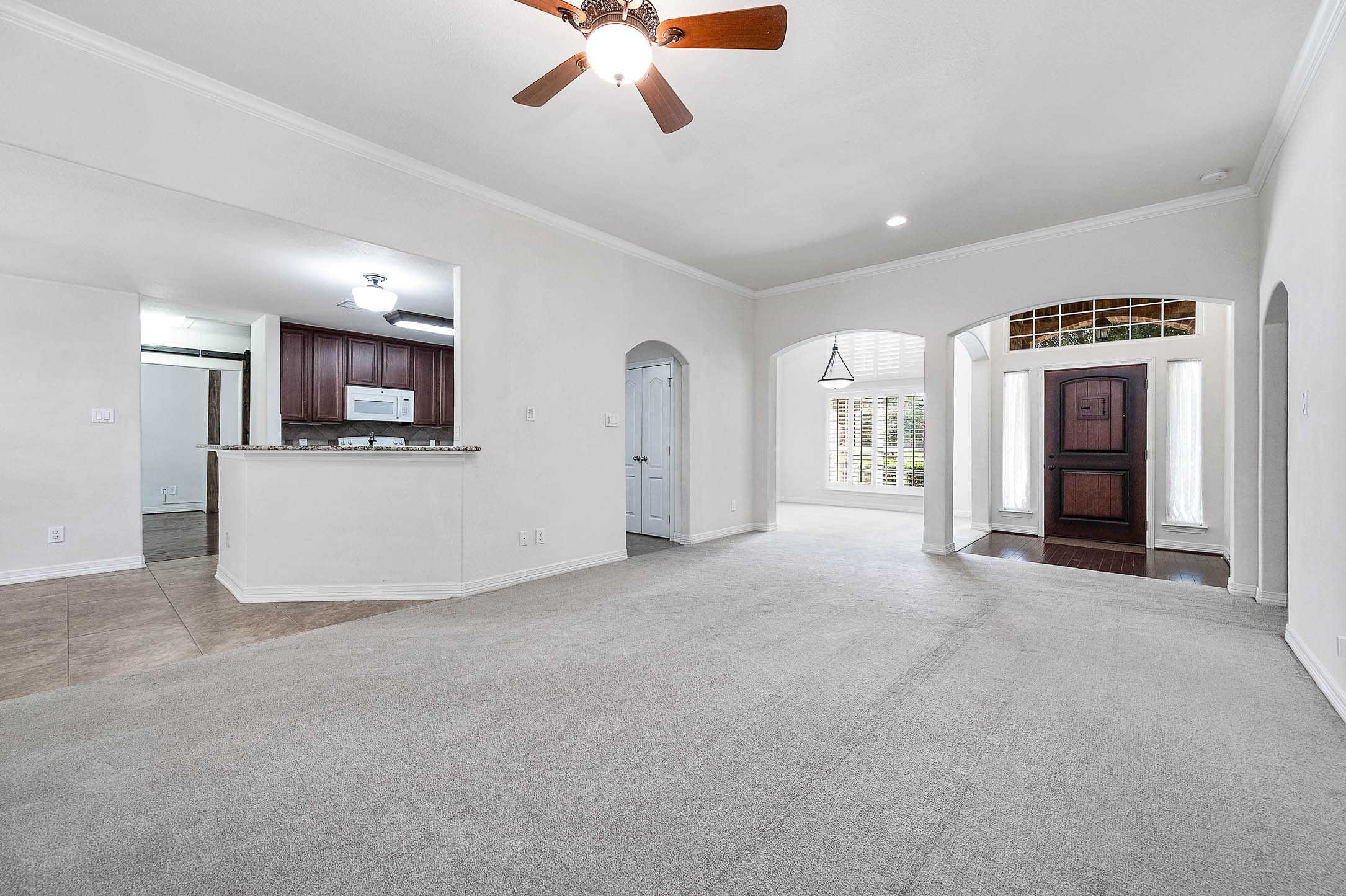 Experience the seamless flow from the inviting living room to the elegant formal dining area, highlighted by a welcoming front entrance.