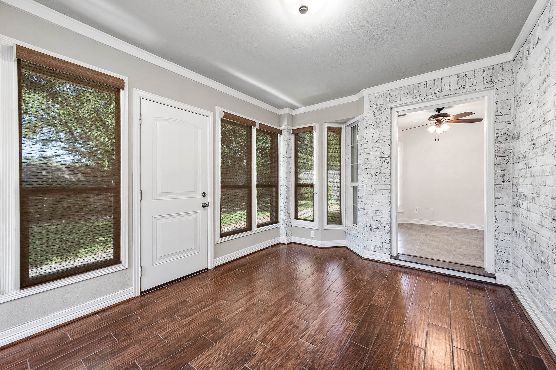 Experience serenity in this inviting sunroom, featuring large windows that flood the space with natural light and offer picturesque views of the lush outdoors.
