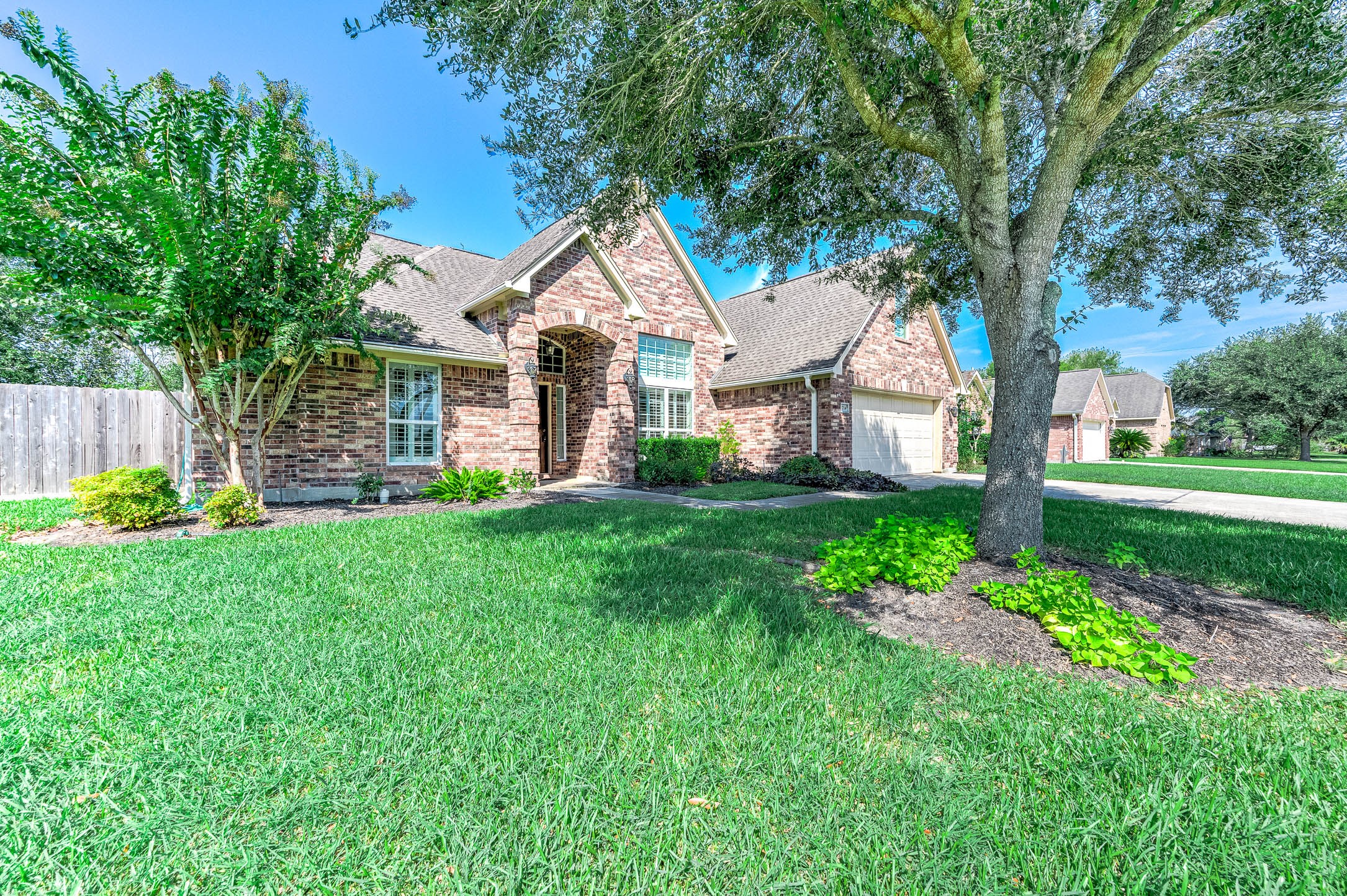 A charming brick home with a mature tree offering cool shade, enhancing the inviting curb appeal. A charming brick home with a mature tree offering cool shade, enhancing the inviting curb appeal.