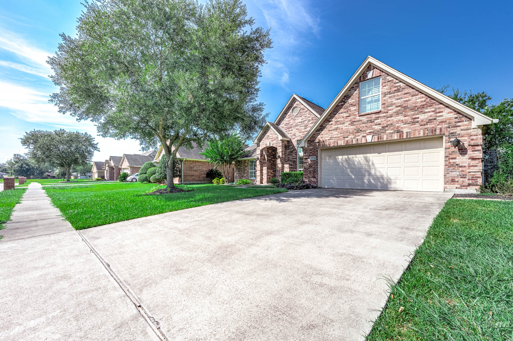 Spacious double driveway and two-car garage provide ample parking for all your needs. Spacious double driveway and two-car garage provide ample parking for all your needs.