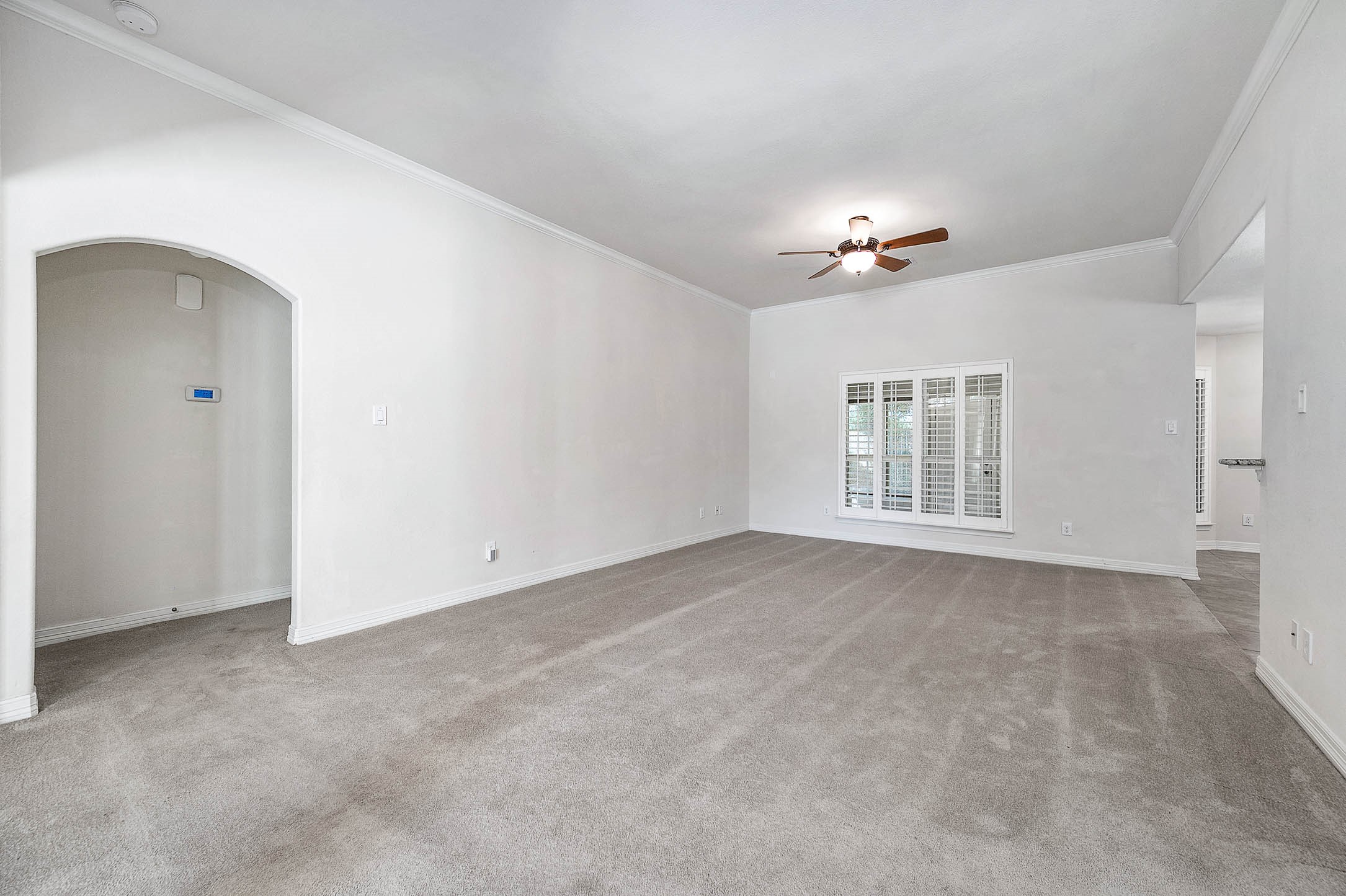 A generously spacious living room perfect for accommodating bulky furniture, seamlessly connecting to the inviting breakfast area and kitchen.