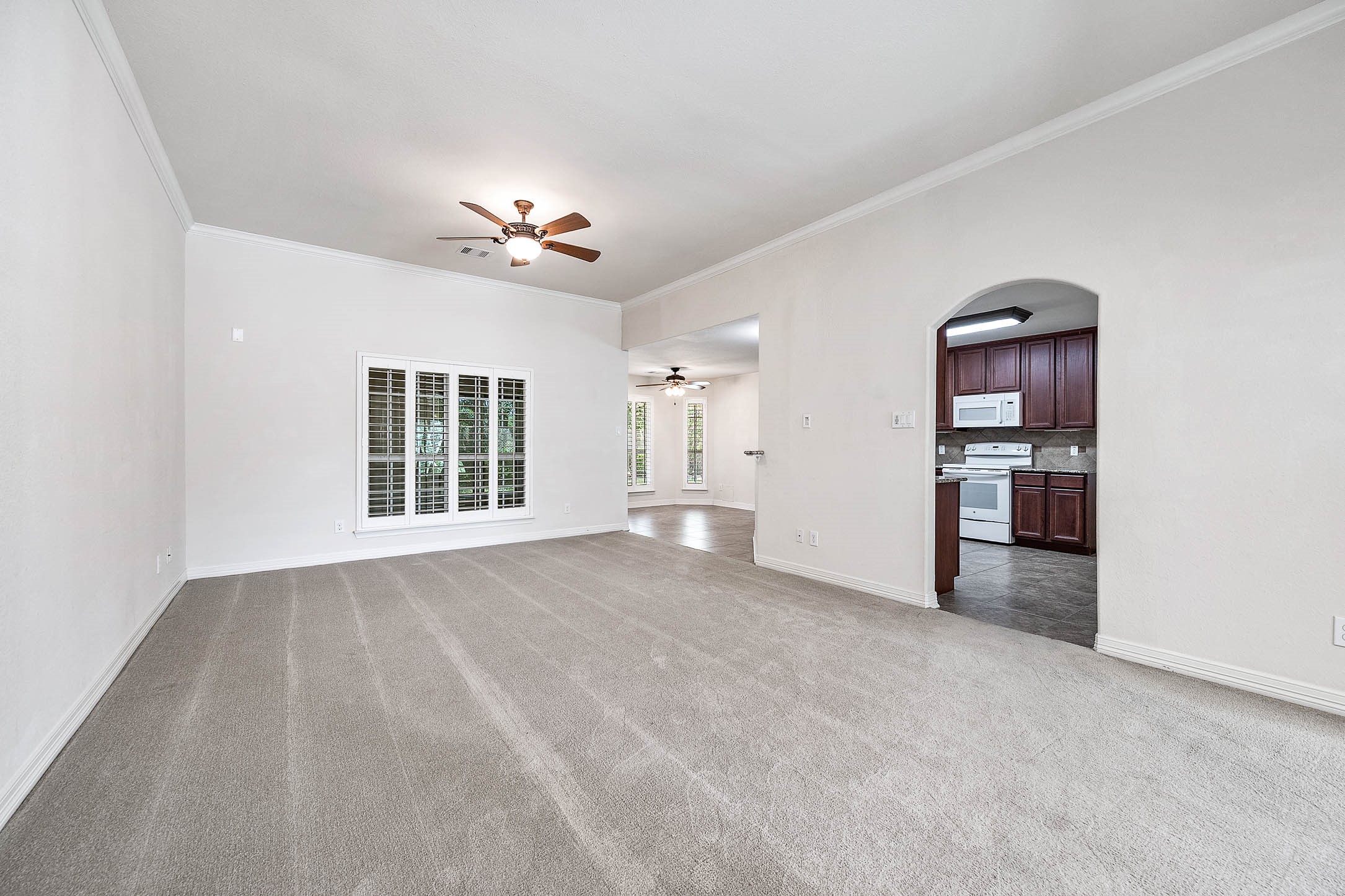 The spacious living room seamlessly connects to the breakfast room and kitchen, creating an inviting flow for easy entertaining and daily living.