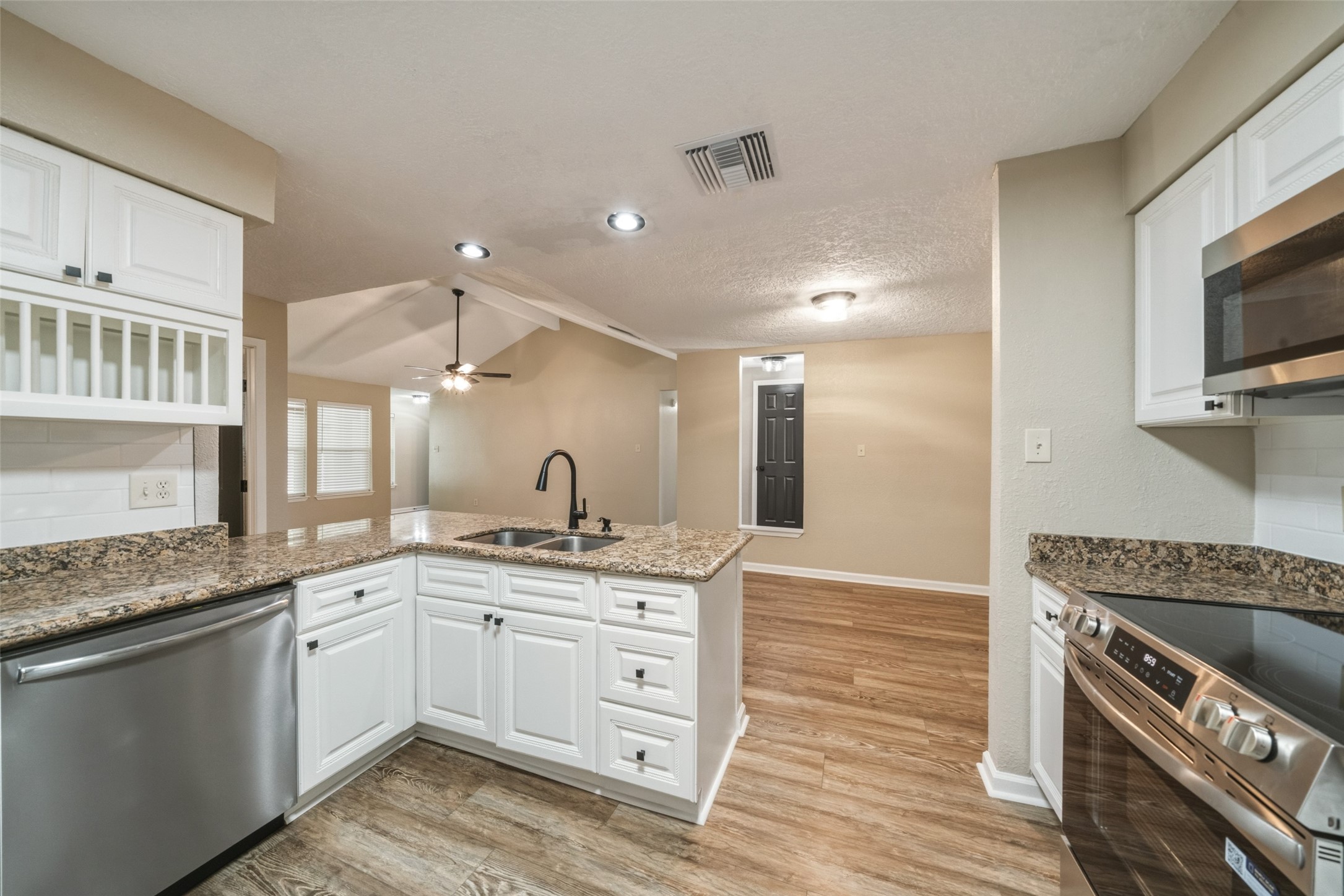 View of the kitchen from the door to the garage. The refrigerator is not in this picture but is included.