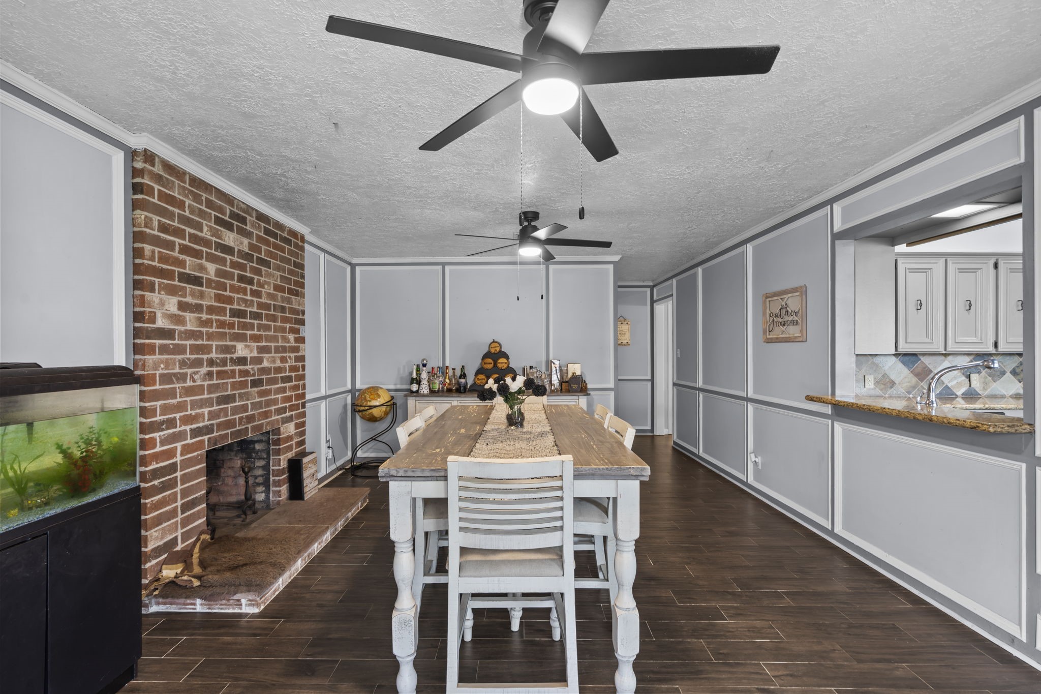 Beautiful dining room with exposed brick fireplace.