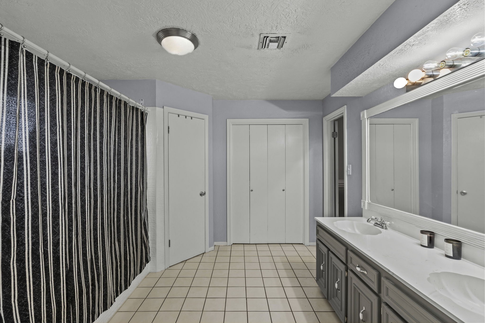 Primary bathroom with double sinks and plenty of storage.