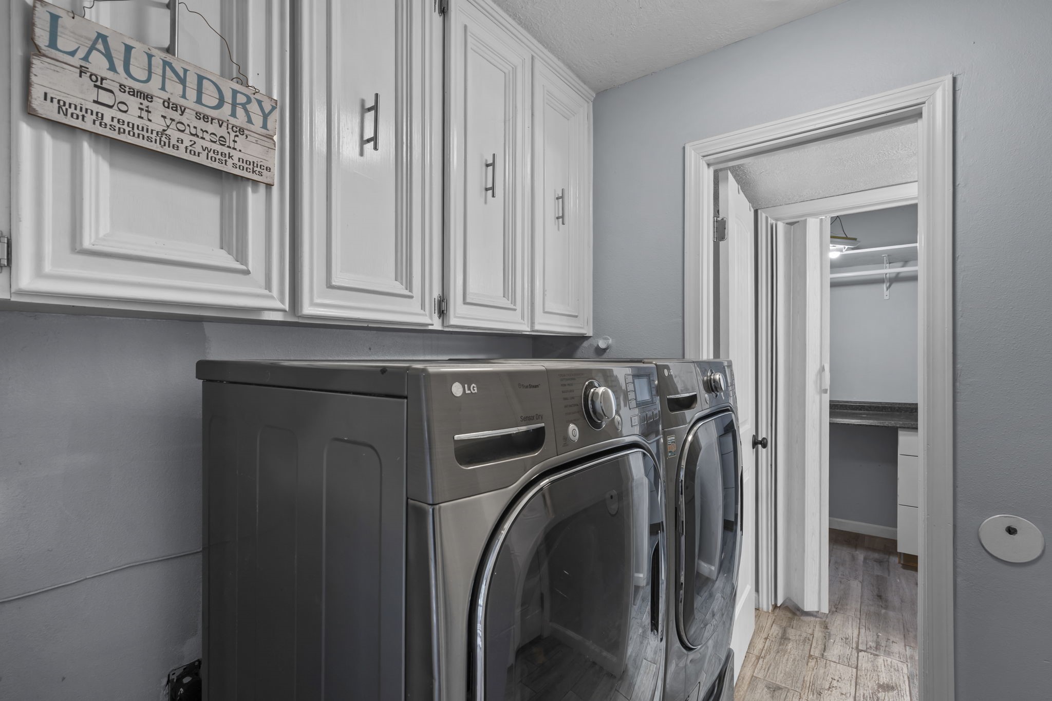 Utility room in the house with attached 1/2 bath and storage.