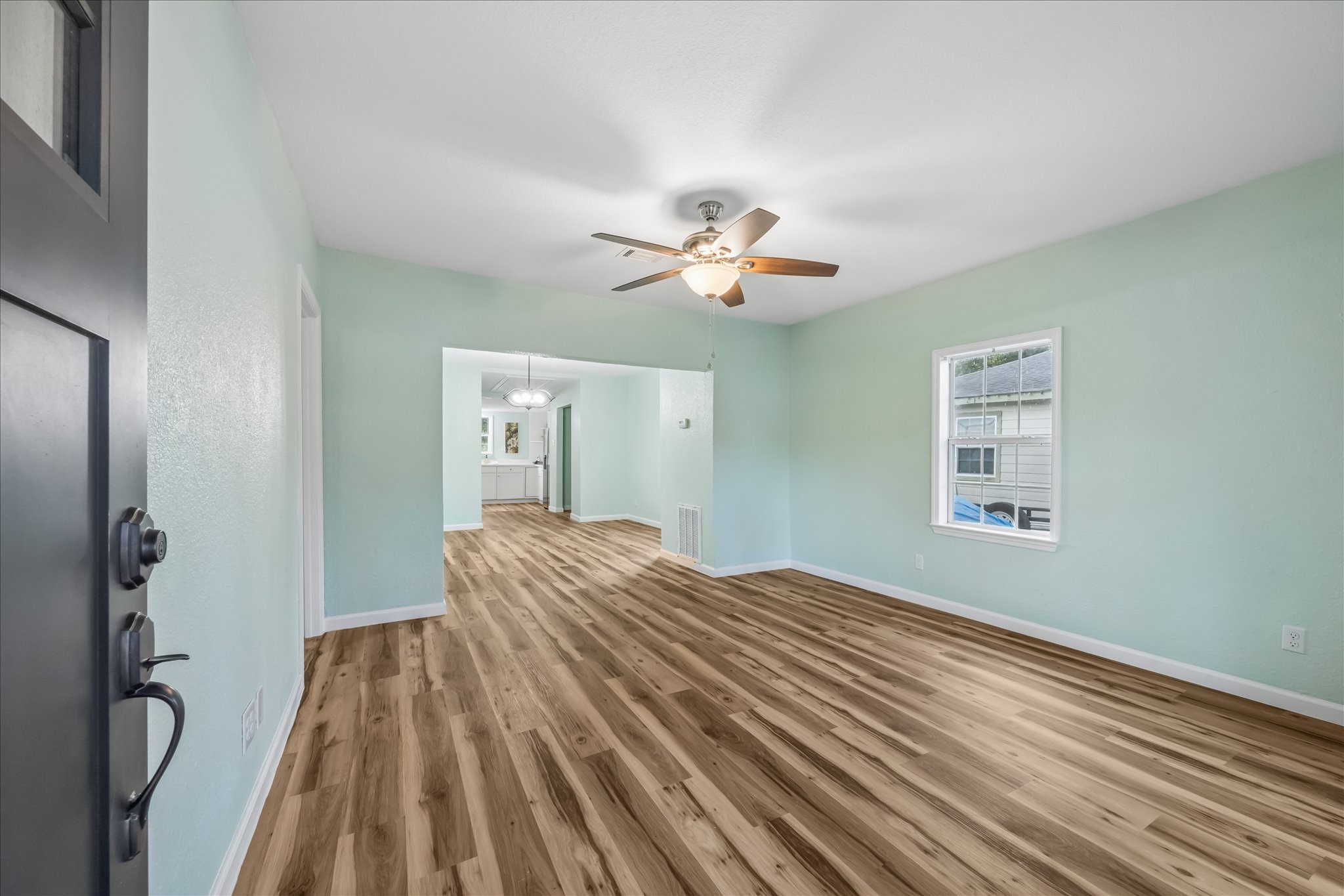 Bright living room with new LVP flooring and fresh paint.