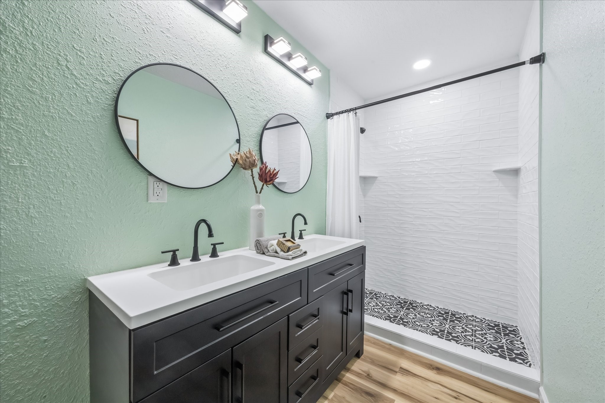 Primary bath with double sinks and an oversized walk-in shower.