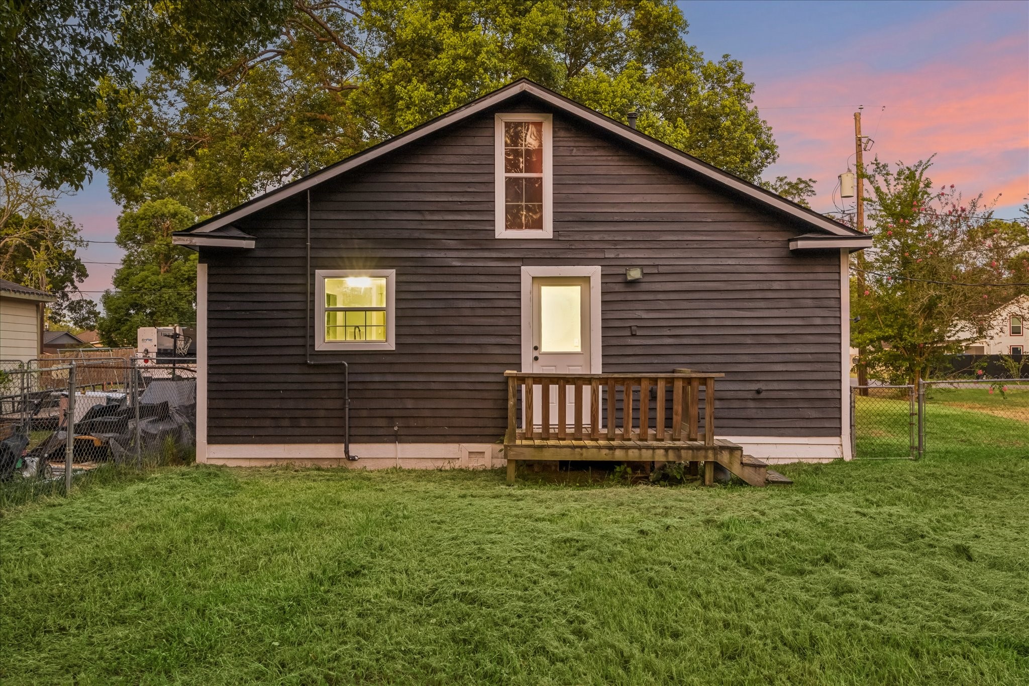 Rear exterior at sunset with plenty of surrounding yard.