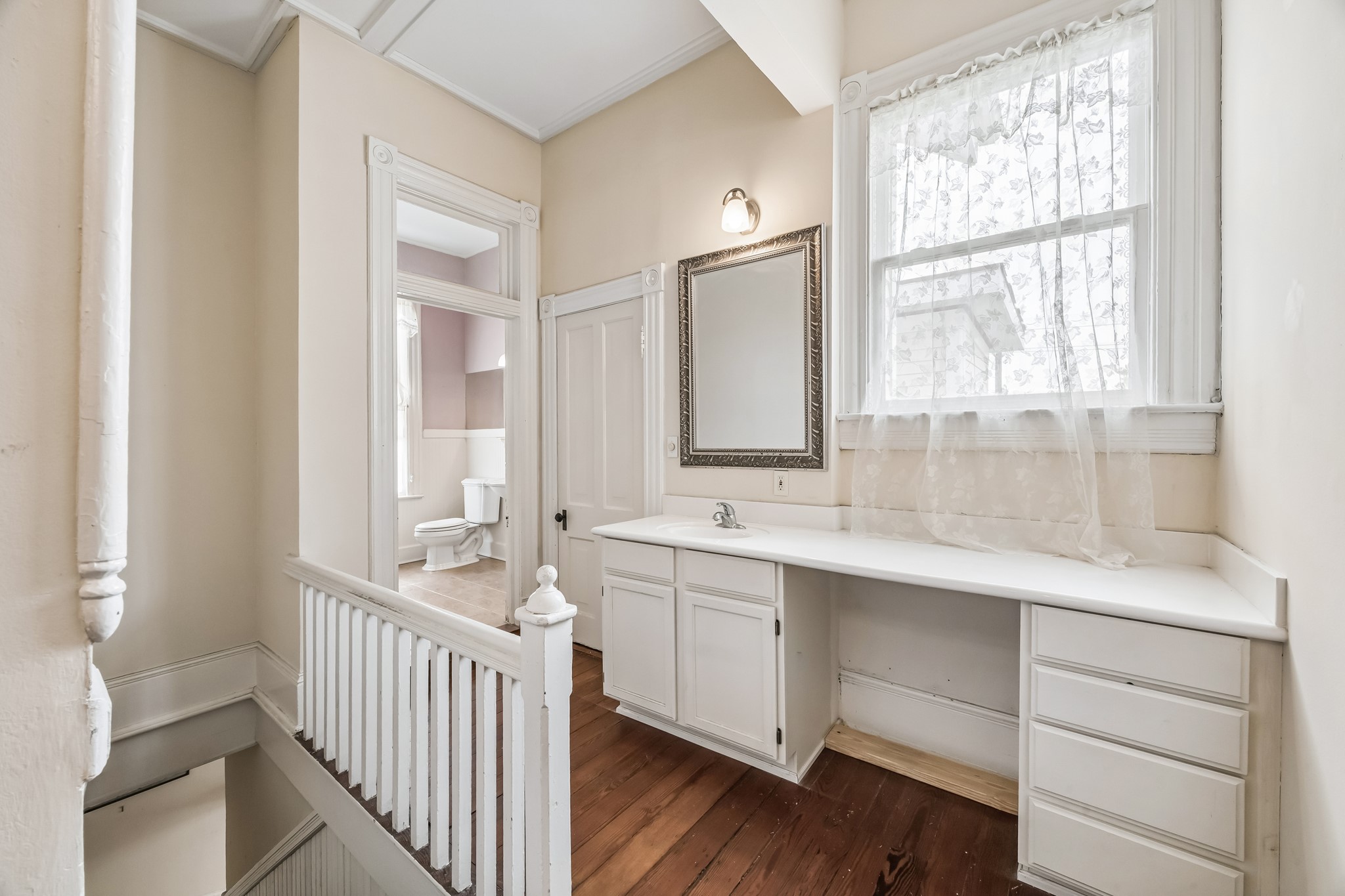 The primary bath has a vanity area with a sink