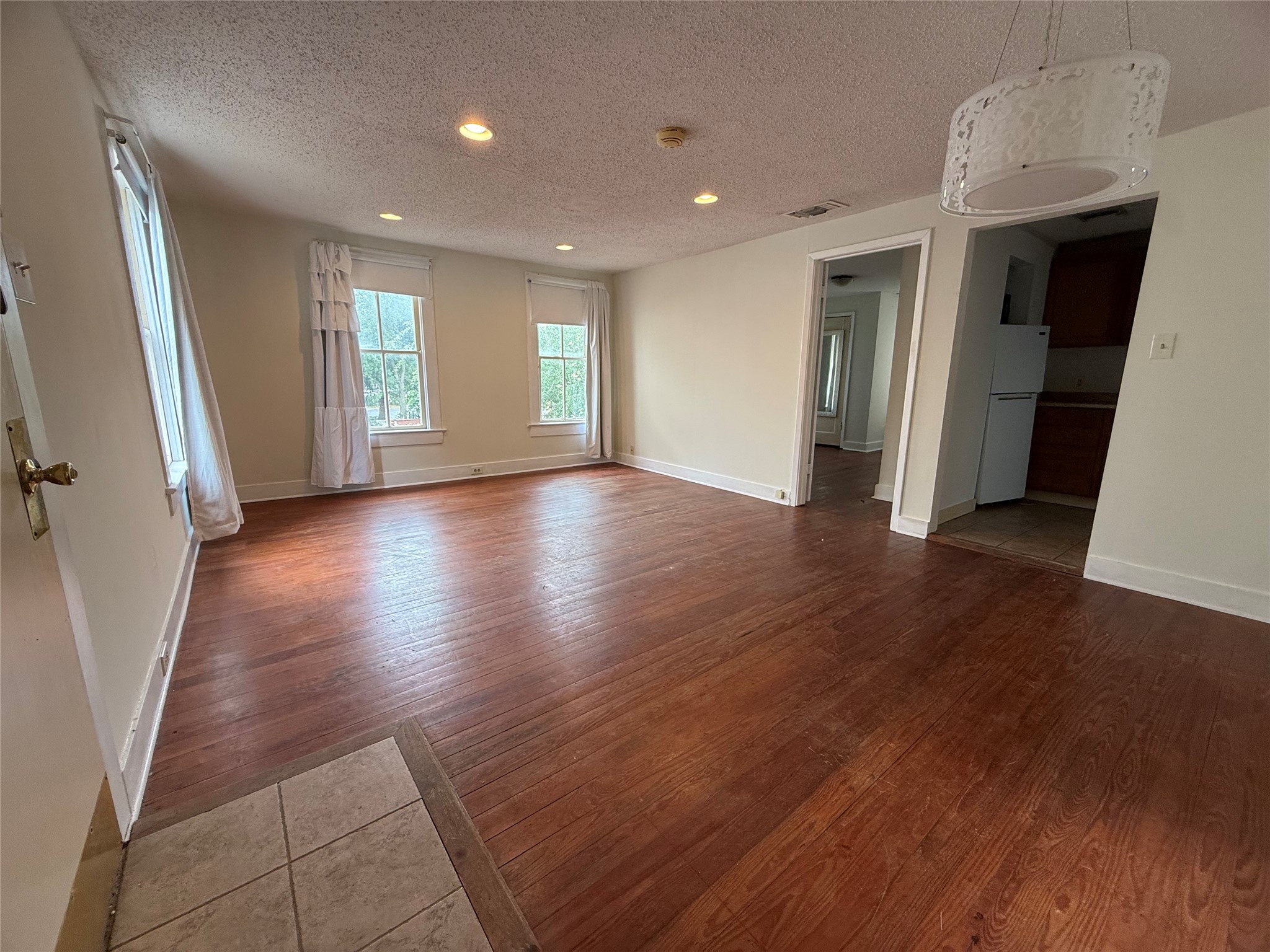 The garage apartment provides one of the income producing units in the home. Large living area with original wood floors