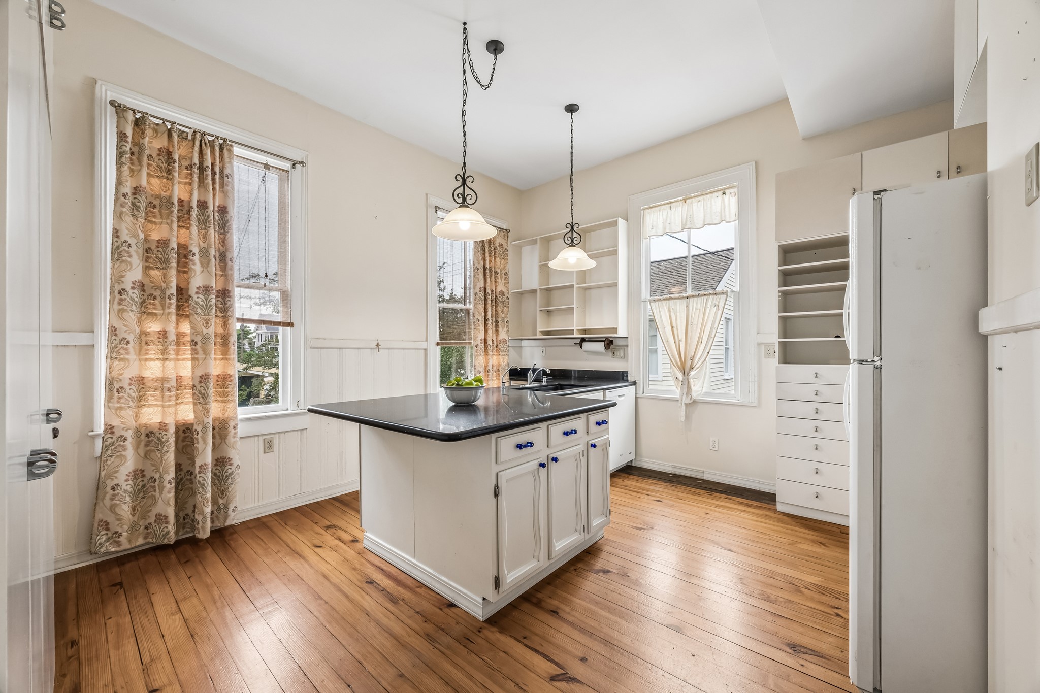 A modern kitchen. The first room is the prep kitchen. Here you have all your storage, plenty of counter space, and a breakfast bar