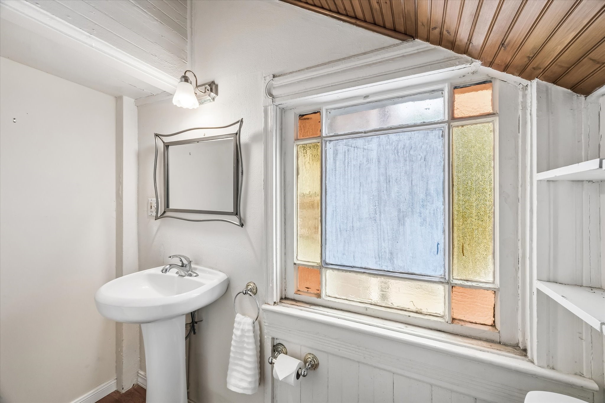 The half bath has an original window
