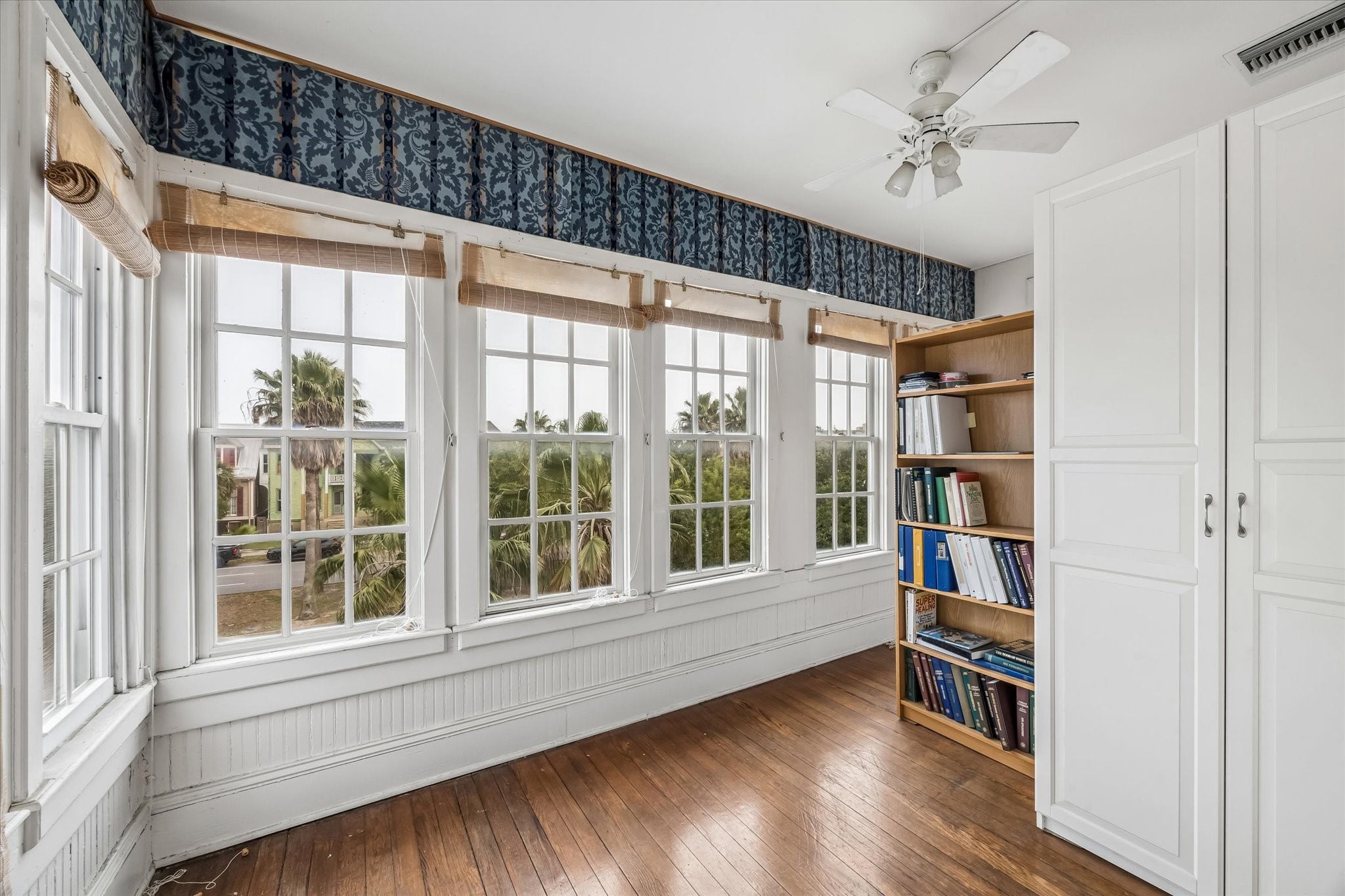 The sun room was used as a craft room and sewing room. The cabinets can be removed to open up the entire space