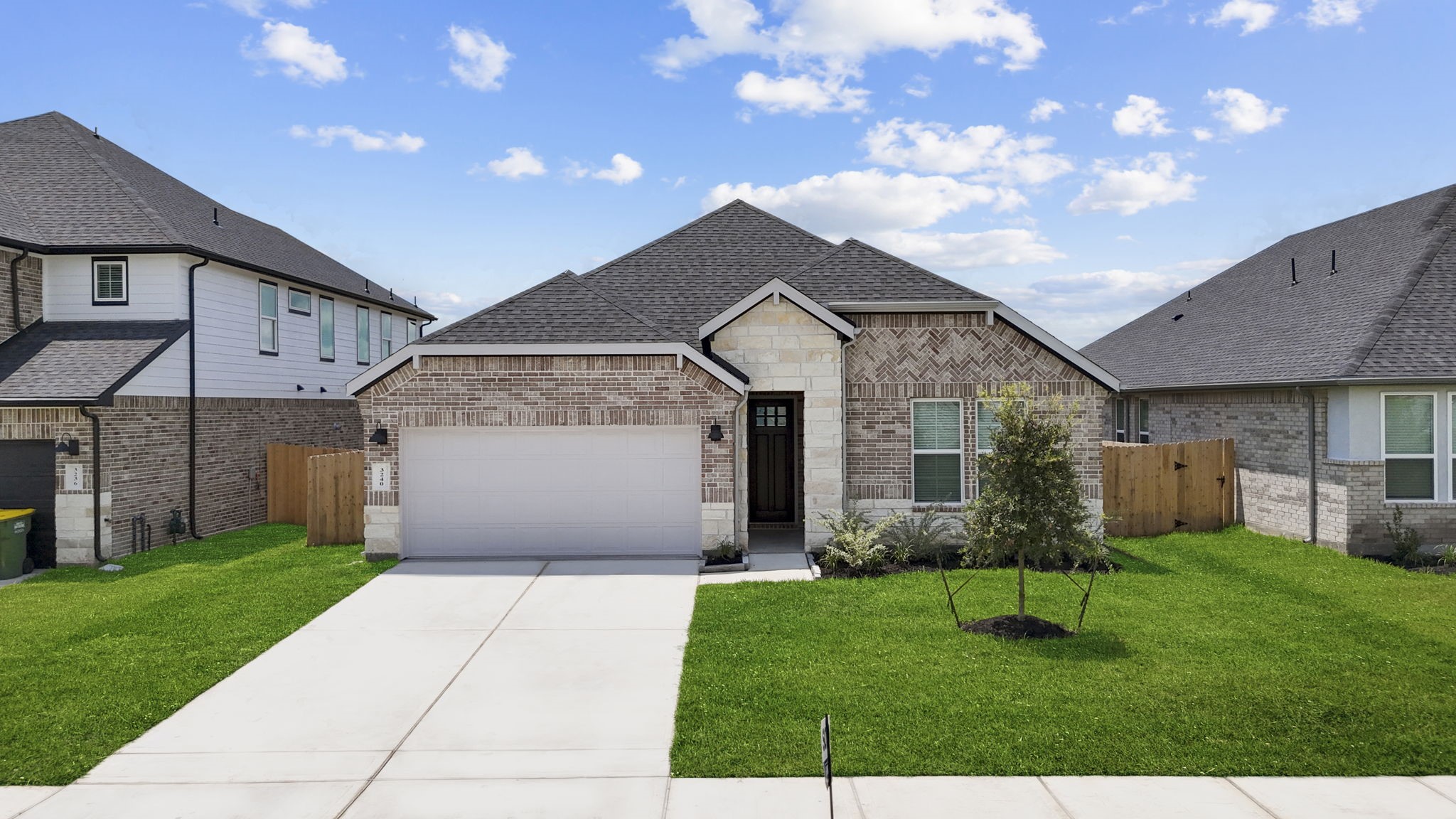 one story home with a covered front door area and a two car garage