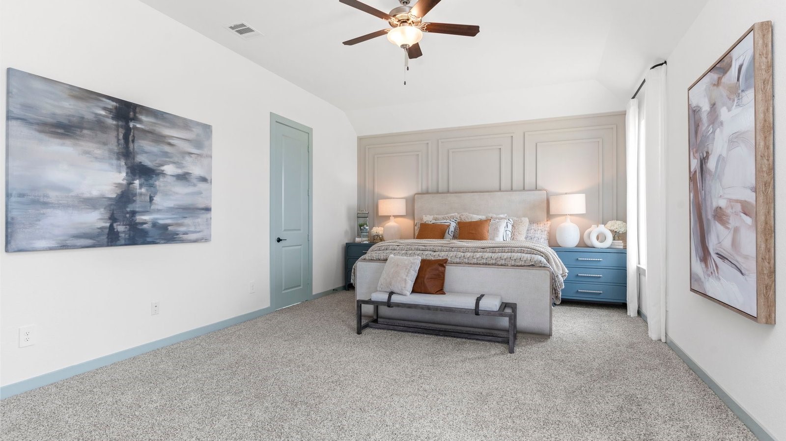 primary bedroom with a ceiling fan and large windows for natural lighting