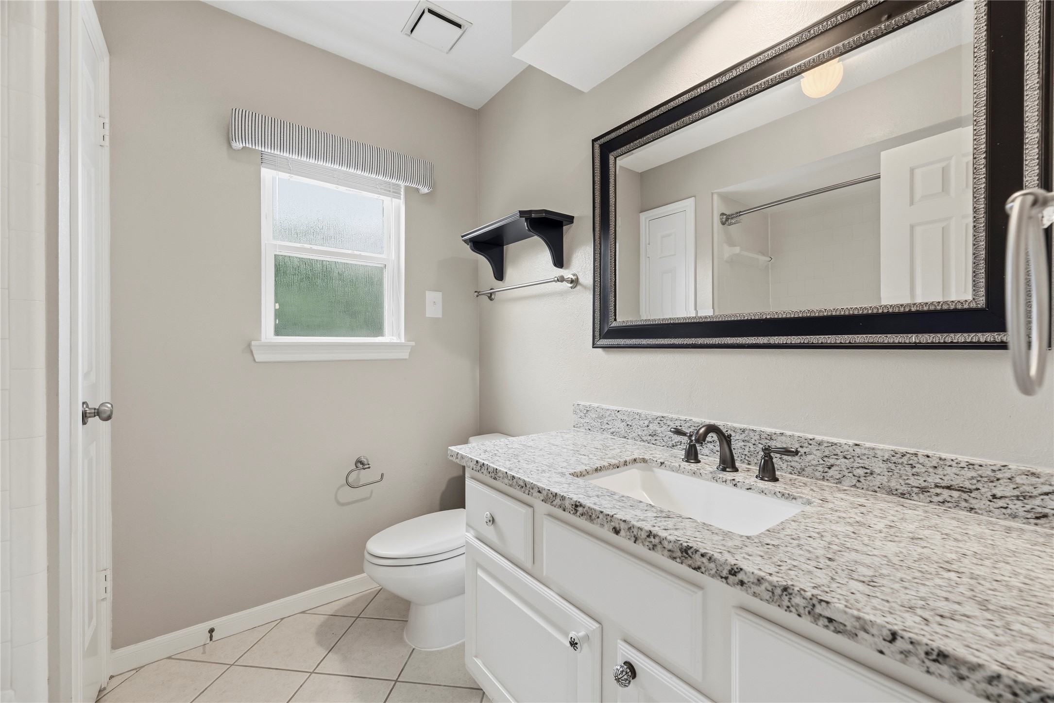Bathroom #3 features granite countertops and a shower/tub combo.