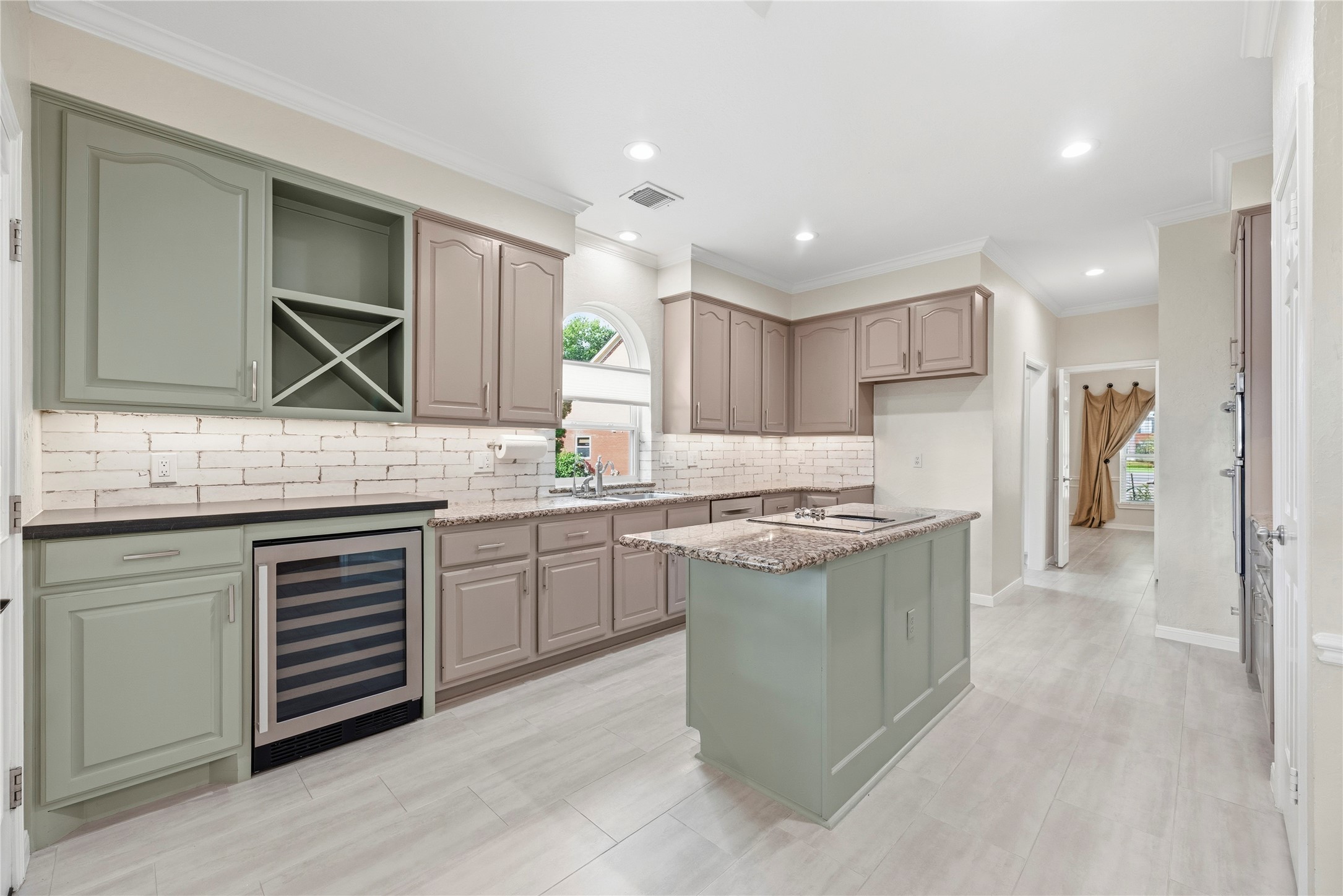 The custom cabinetry features a built-in wine fridge and undercabinet lighting that adds a modern, functional touch.