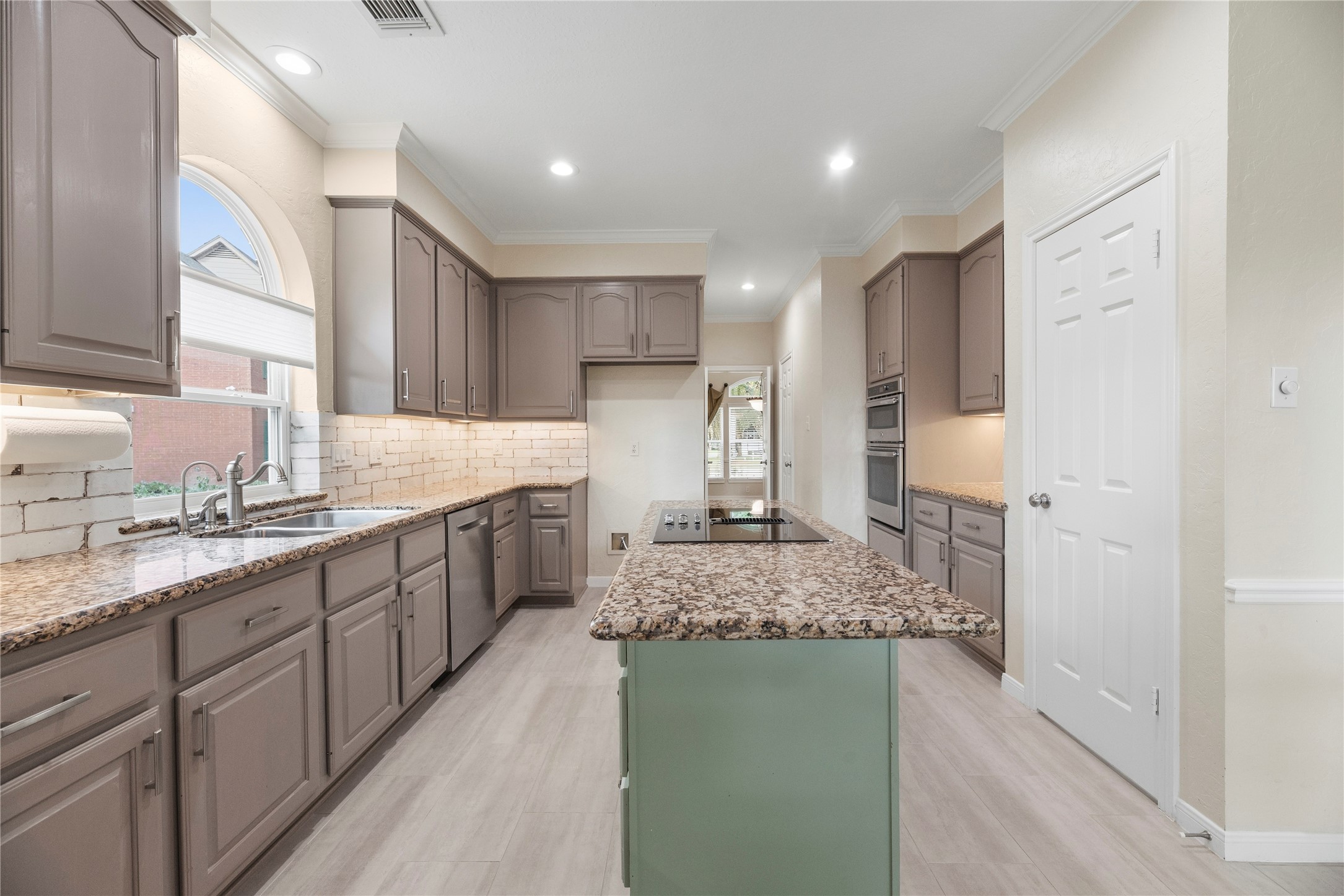 This kitchen has updated stainless steel appliances, perfect for culinary enthusiasts and entertaining.