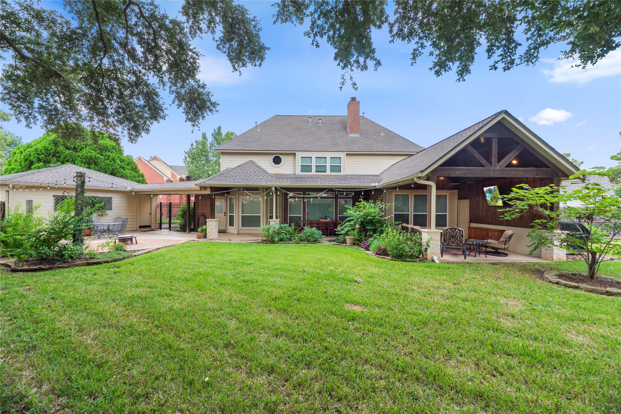 Wow this yard! Spacious backyard with a giant covered patio is perfect for entertaining and relaxation. Gardener's dream with years of perennial plants!