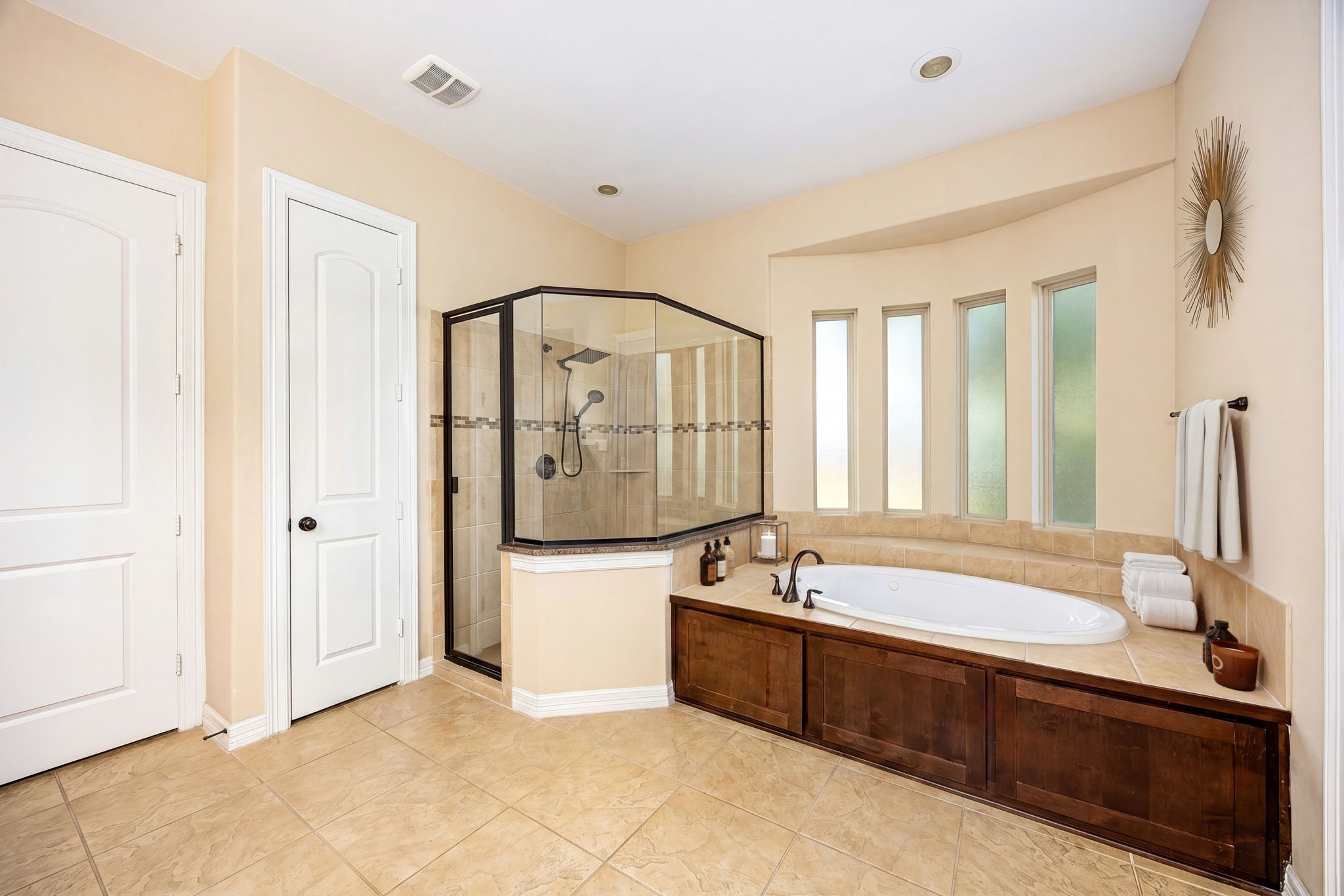 Spa vibes at home! Unwind in the deep soaking tub or refresh in the oversized glass-enclosed walk-in shower with tile surround and rain showerhead. The ultimate daily escape.