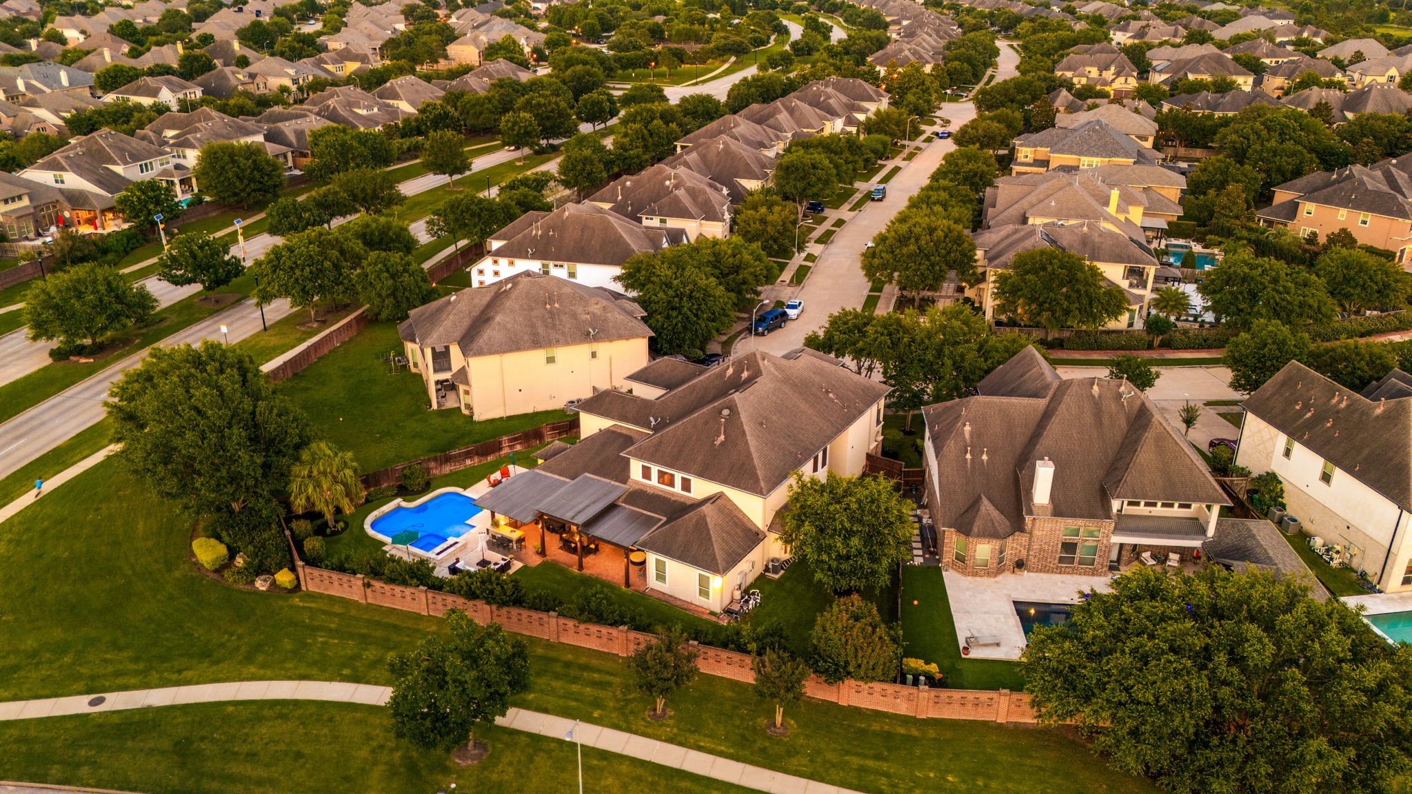 Tree-lined streets, lush green lawns, and a tight-knit community vibe, this aerial shot captures exactly why Cinco Ranch Southwest is one of Katy's most sought-after communities. Pool and pergola visible right from above!