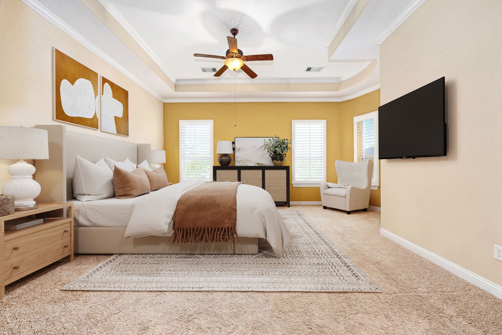 Your personal retreat awaits! This spacious primary suite features a gorgeous tray ceiling with crown molding, ceiling fan, plush carpet, plantation shutters, and warm golden accent walls. Pure luxury. *Virtually Staged