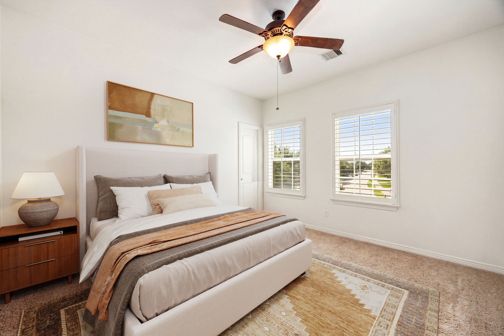 Bright and airy secondary bedroom featuring plush carpet, plantation shutters, and a ceiling fan, filled with natural light and ready to make your own! *Virtually Staged