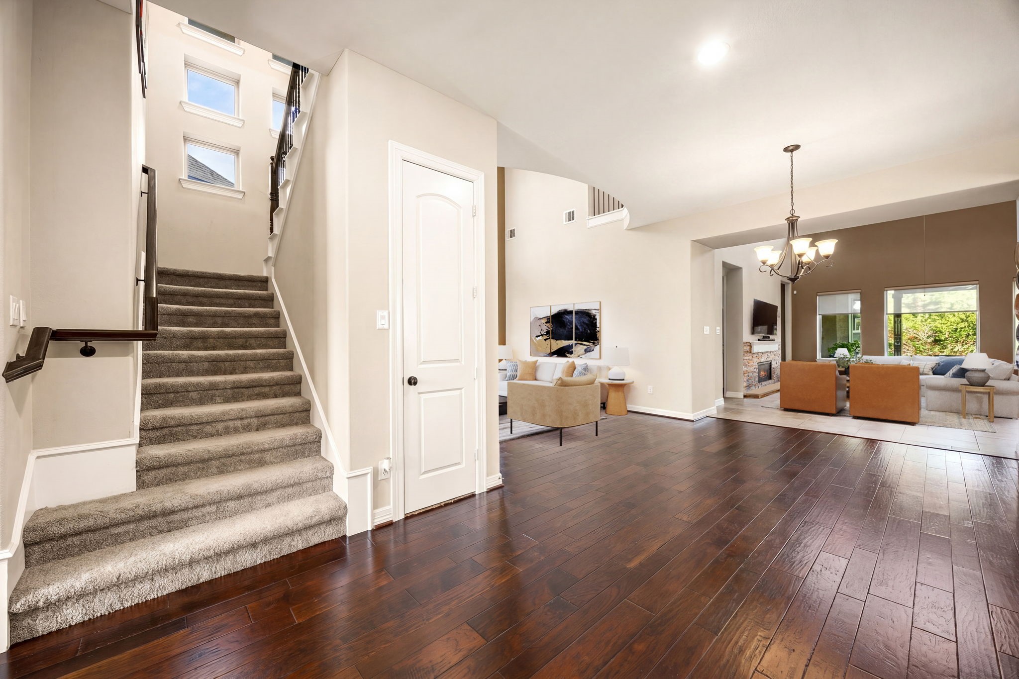Grand entry vibes! Rich hardwood floors, soaring ceilings, and a sweeping staircase welcome you in while opening beautifully into the spacious living area beyond. This home makes a statement from the moment you walk through the door. *Virtually Staged
