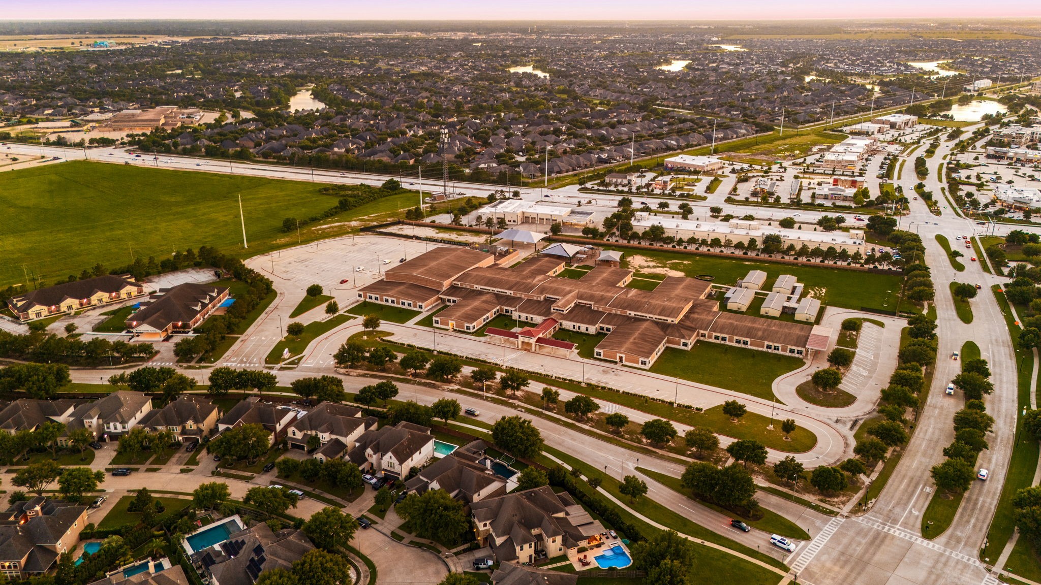 This incredible aerial view showcases the proximity to top-rated schools, wide tree-lined streets, and the beautifully established Cinco Ranch Southwest community. Location doesn't get better than this!