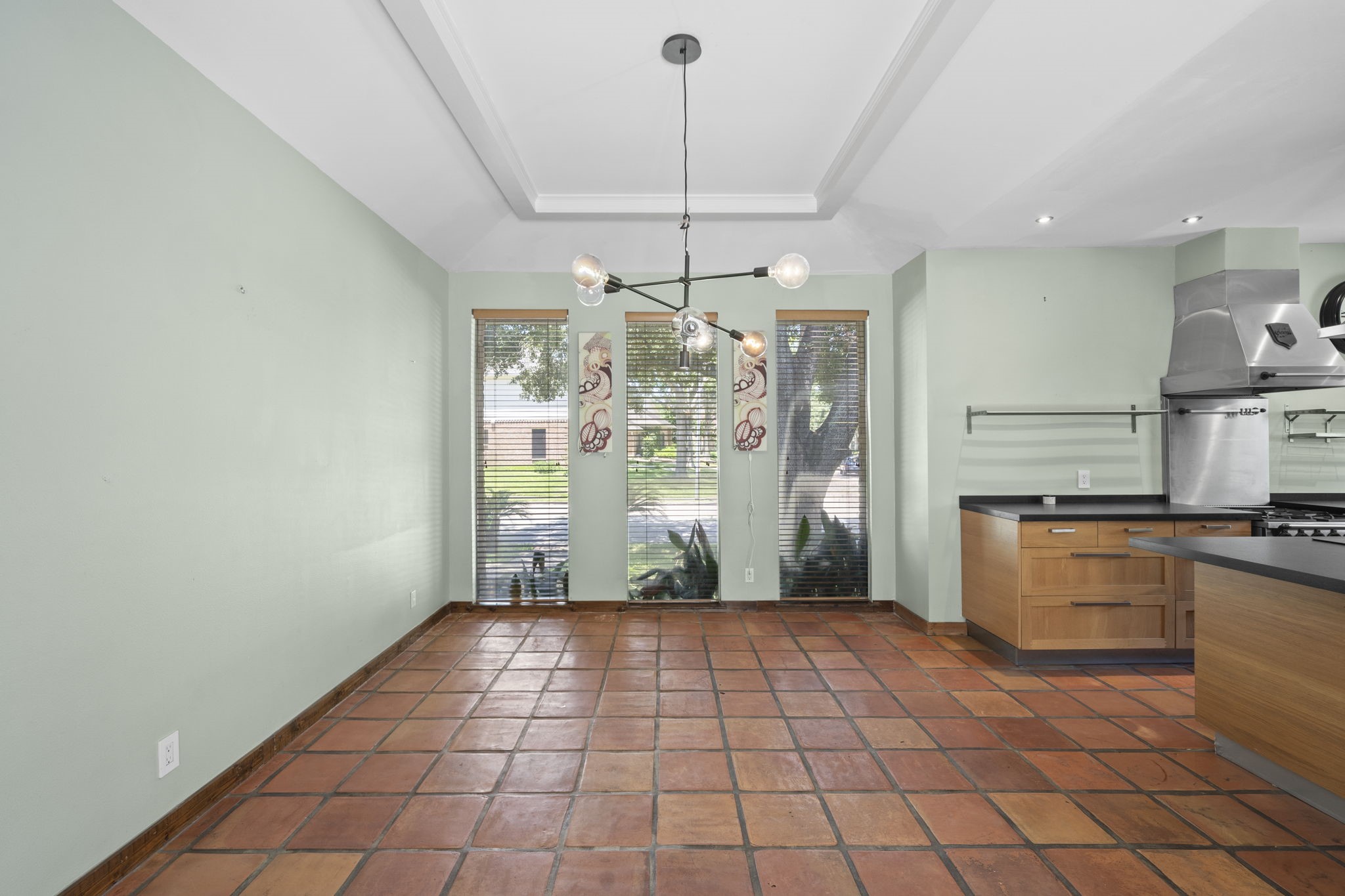 The dining room offers a spacious setting just off the kitchen, with natural light, wood flooring, and direct connection to the main living spaces. The room creates a polished place for meals, hosting, and everyday use.