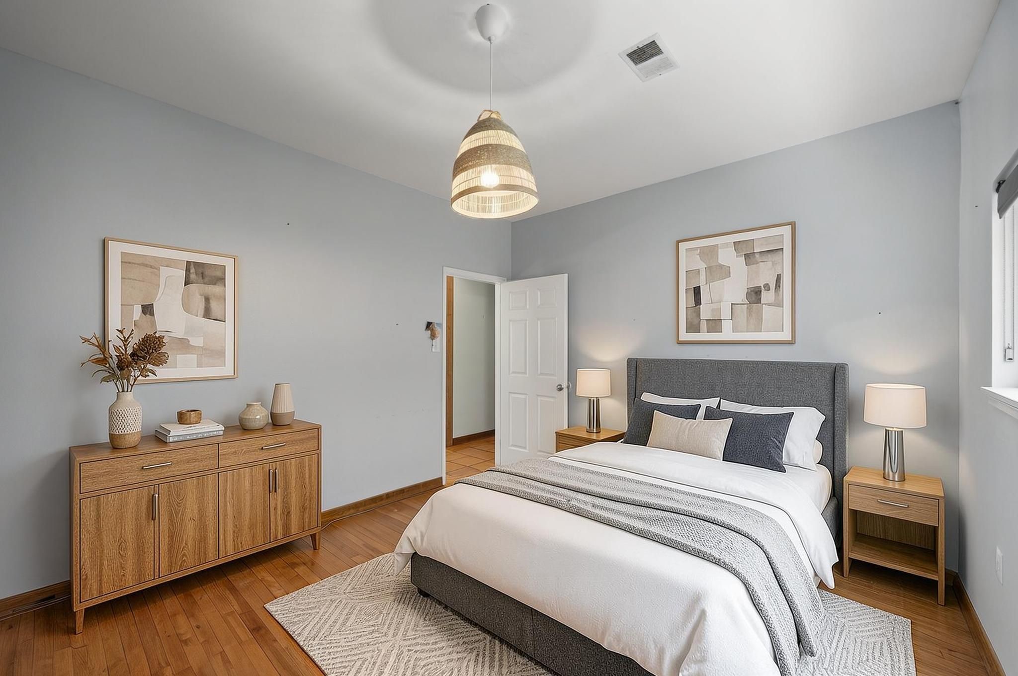 This additional bedroom offers usable space with natural light and wood flooring. It works well as a bedroom, office, hobby room, or guest space. Virtually staged.