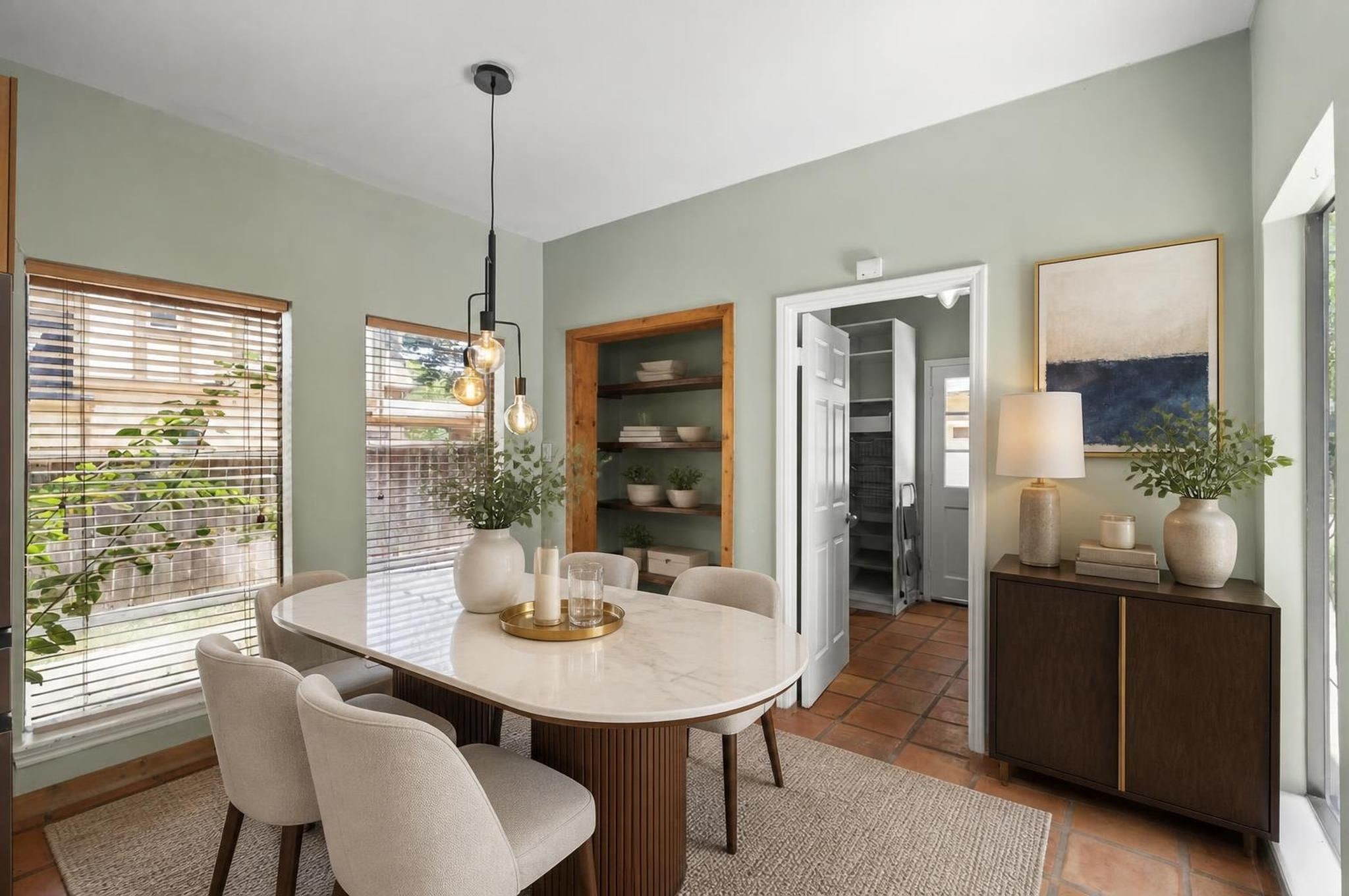 The breakfast area sits near the kitchen with backyard views and easy access to the patio spaces. It creates a bright everyday dining area separate from the formal dining room. Virtually staged.