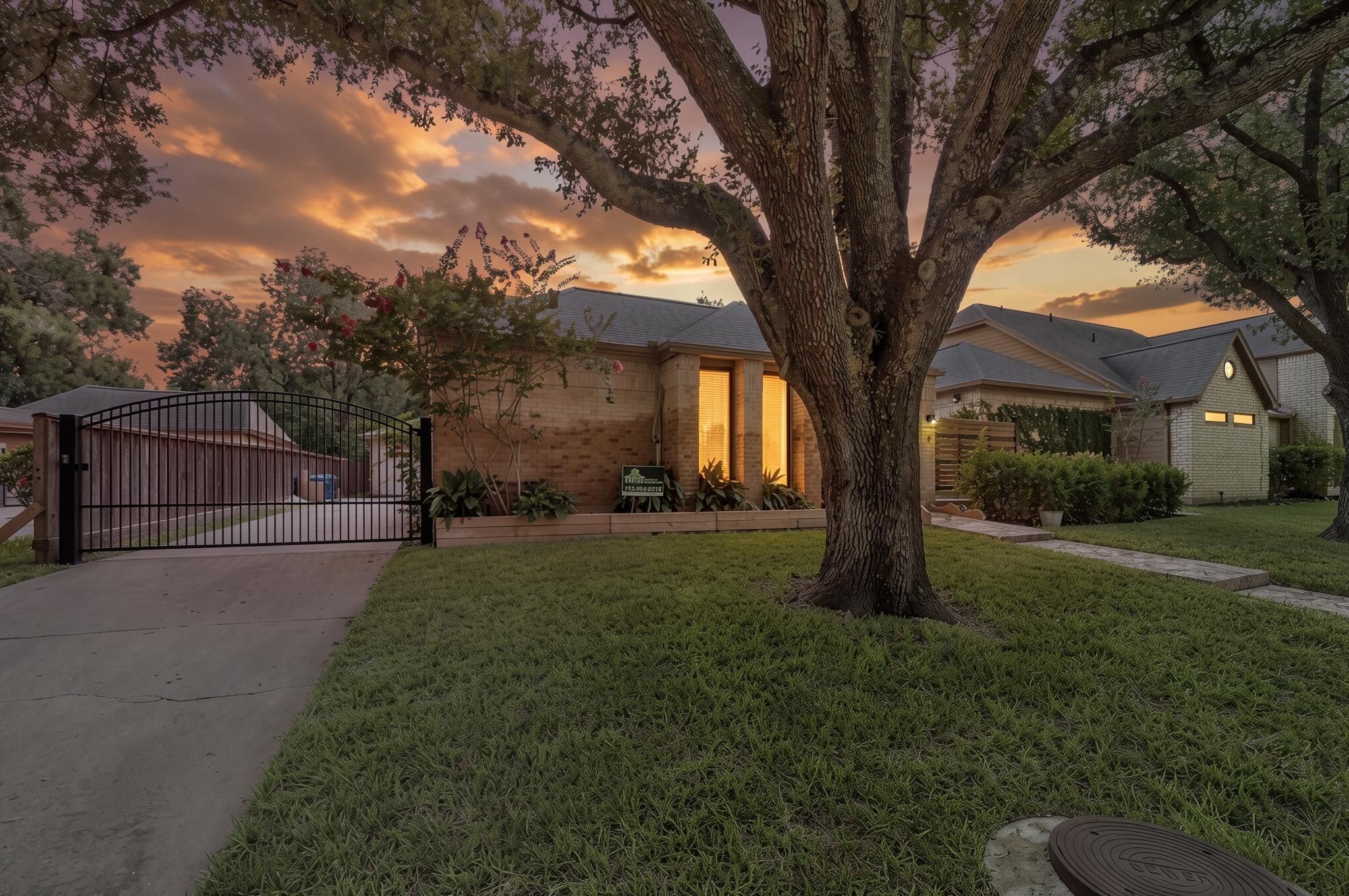 The gated driveway adds a more private approach to the property while keeping access to the detached garage simple. It gives the home a polished exterior detail that pairs well with the mature landscaping.