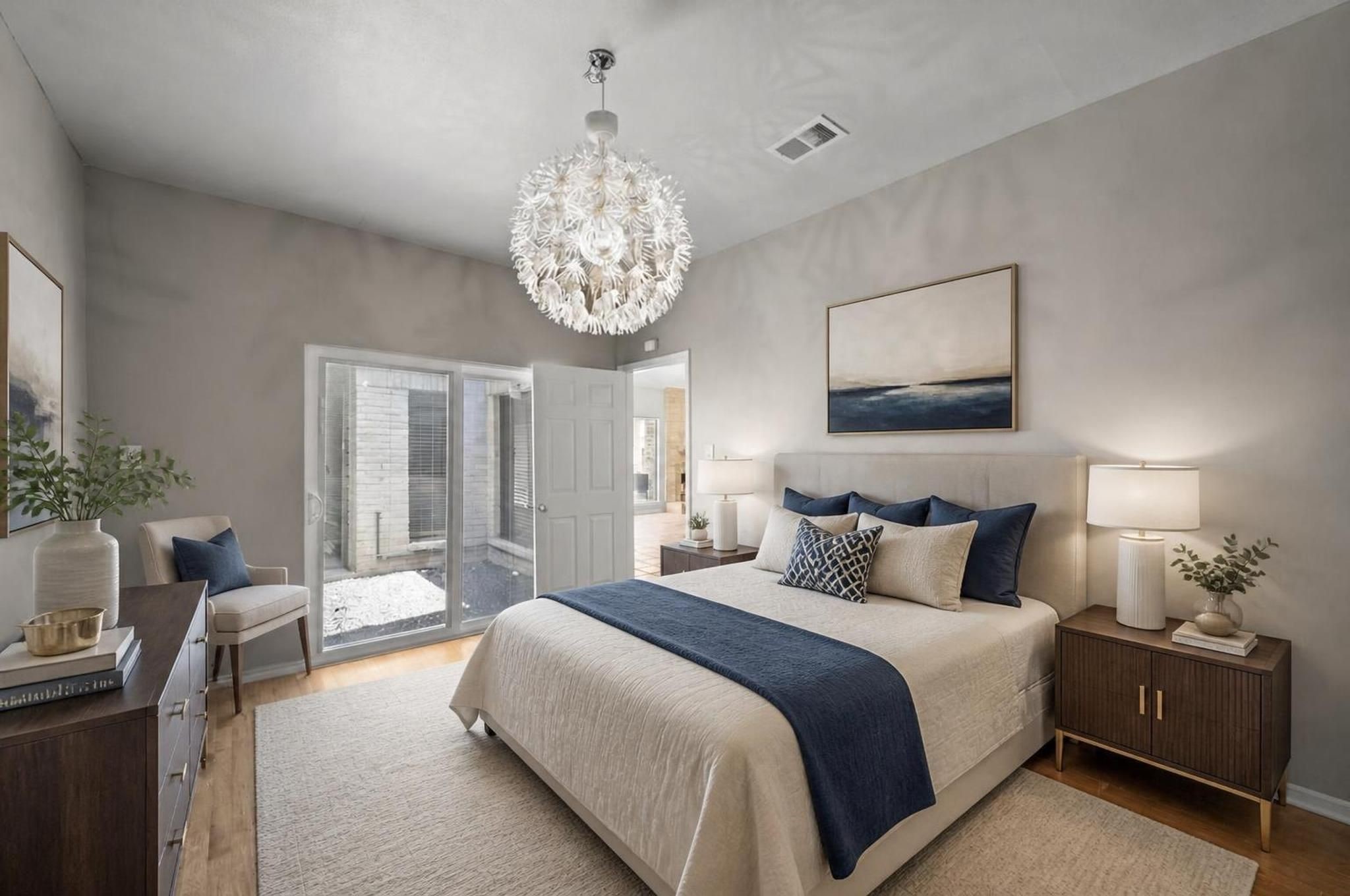 This secondary bedroom offers a comfortable first-floor space with wood flooring, natural light, and a simple layout. It can serve as a bedroom, office, guest room, or quiet retreat. Virtually staged.
