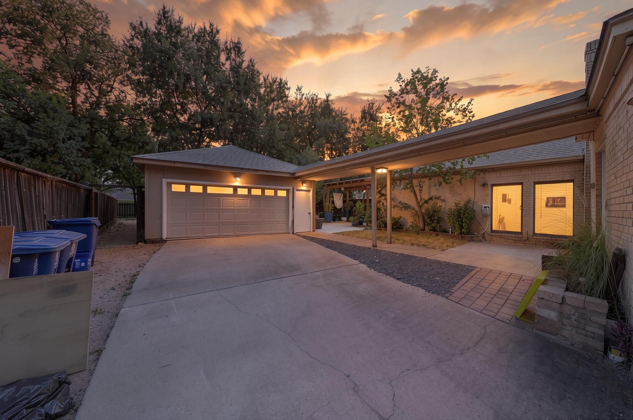 The detached 2-car garage sits beyond the gated driveway and adds useful parking and storage. Its placement helps separate the garage function from the main living and backyard areas.