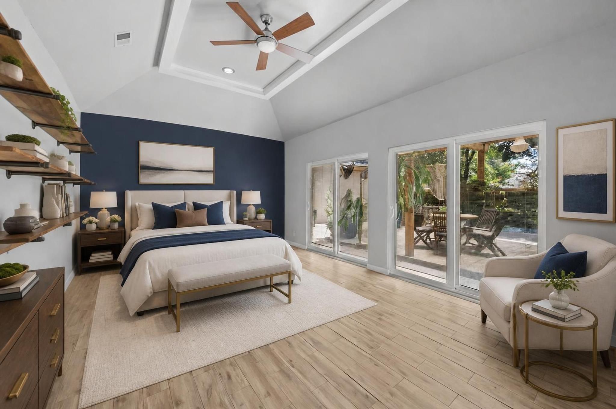 The primary bedroom offers a spacious first-floor retreat with backyard views, vinyl  flooring, and direct access to the ensuite bath. Its placement gives the suite privacy while keeping the entire home on one level. Virtually staged.