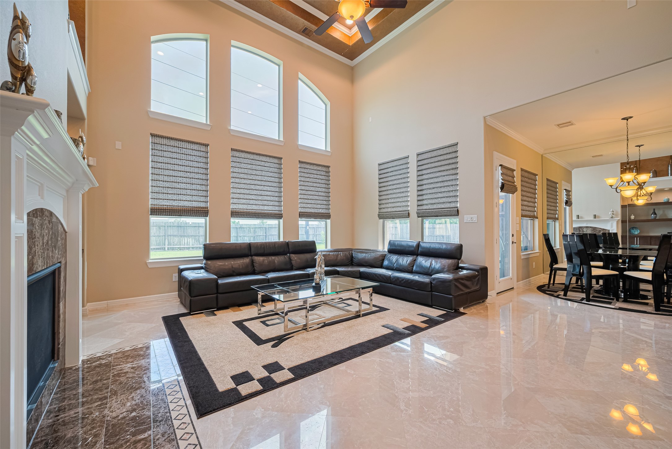 Alternate family room perspective capturing the expansive open layout, towering windows, and seamless connection to the breakfast area.